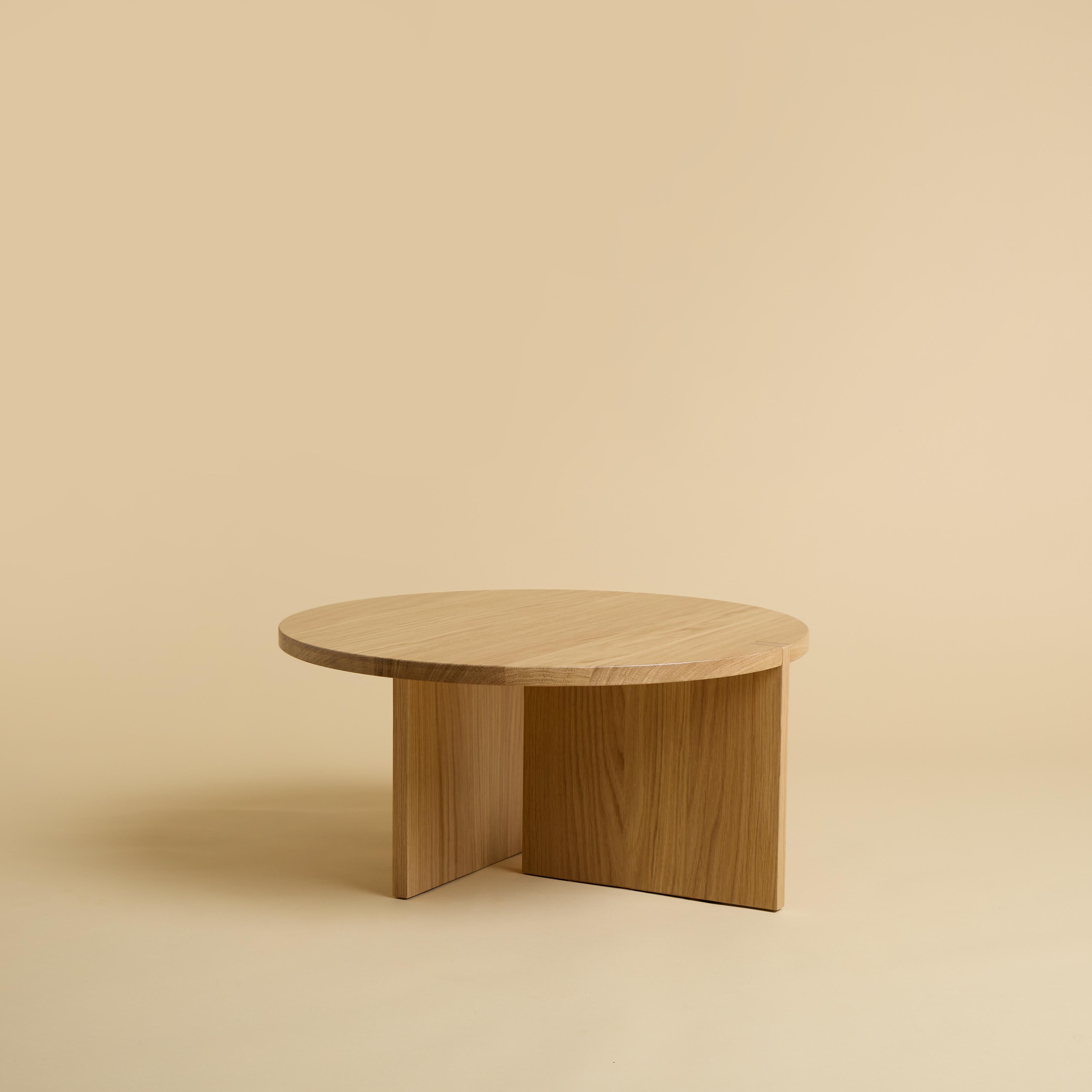 The coffee table Minami is made entirely of solid oak wood. The top is circular and has a diameter of 60cm, the legs are made from two glued solid wood boards in which one part is inlaid on the top.
The piece is designed by Lebanto and is 100% Made
