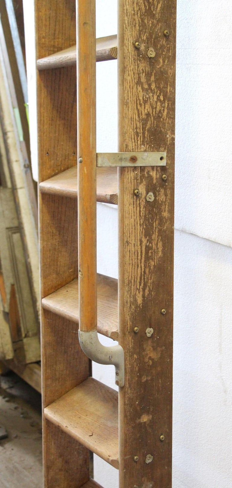 Light color oak library ladder features 12 steps and a right side original handrail. Very sturdy. Small quantity available at time of posting. Priced each. Please note, no wheels.