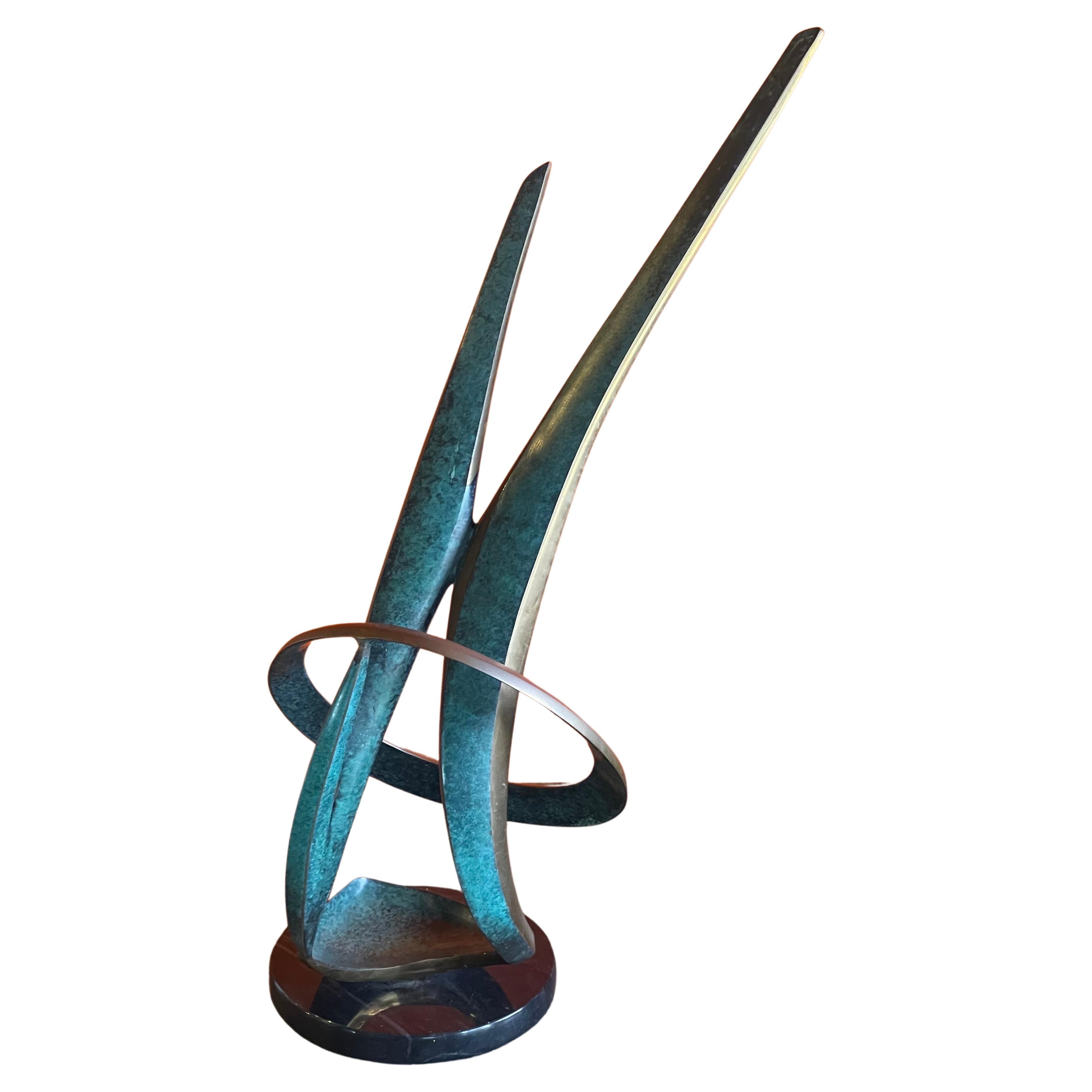 Solid patinated bronze post-modern abstract sculpture on black marble base by listed artist Bob Bennett, circa 1990.  The piece has a great look and beautiful finish and patina; it measures 11