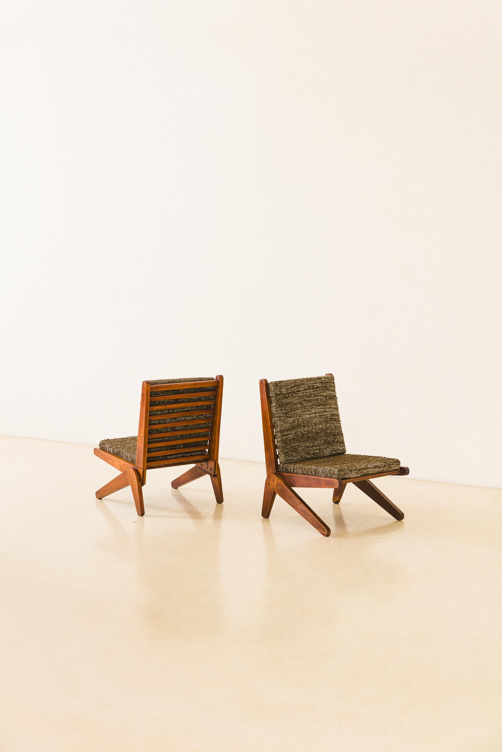 Designed and manufactured in the 1950s, these lounge chairs were built in Solid Pau Marfim Wood. The legs and backrest have a 