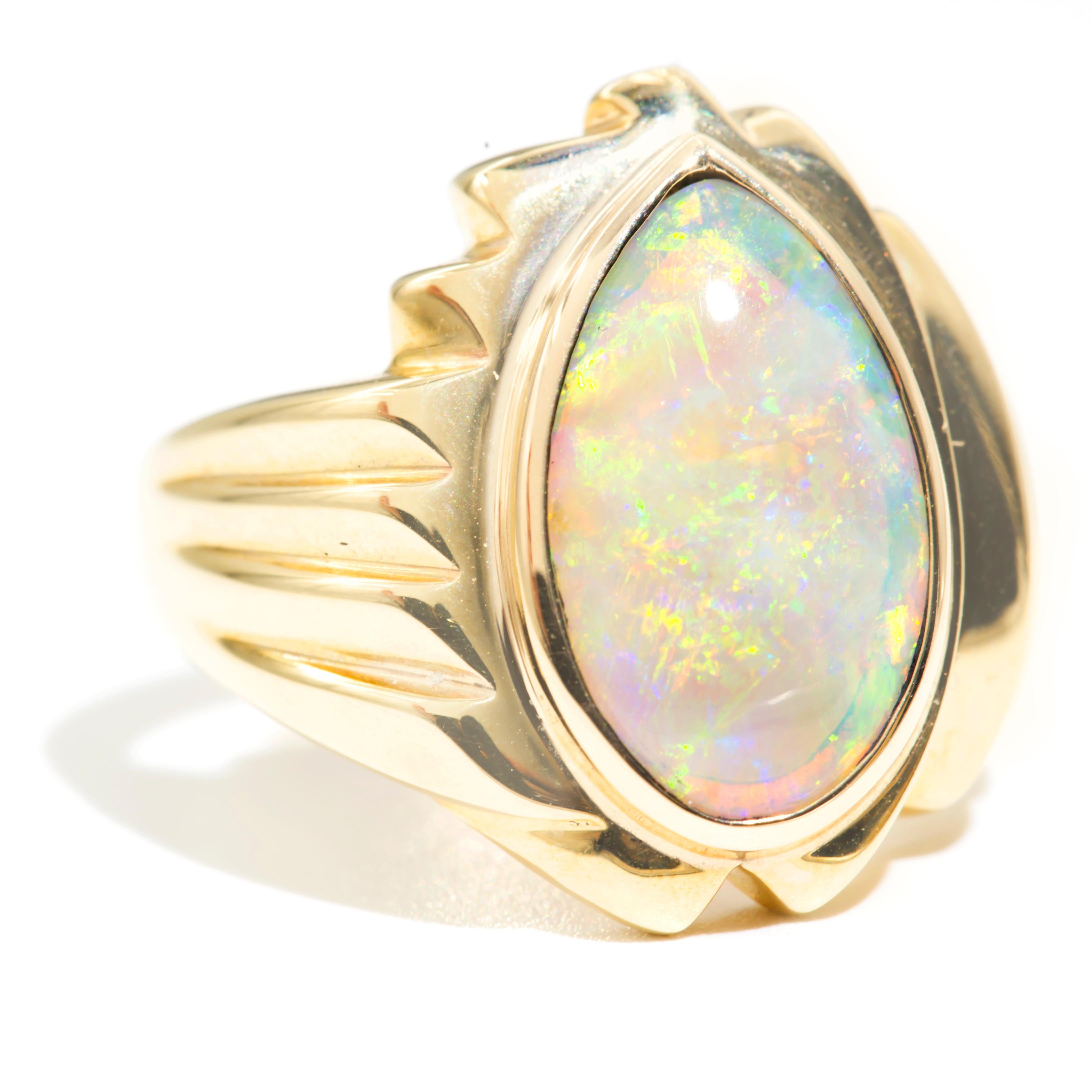 Forged in 9 carat yellow gold is this wondrous vintage signet style ring featuring an enchanting pear shaped solid opal.  We have named this captivating ring The Fran Ring. The Fran Ring has smooth, curved lines flowing down to a grooved stepped