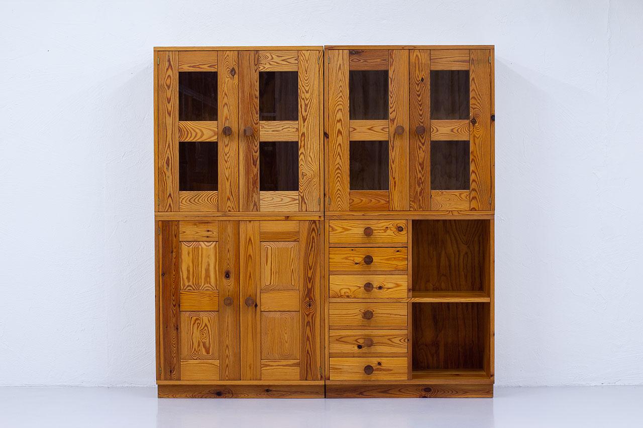Rare cabinets in solid pine manufactured by Luxus in Sweden during the 1960s. 
Designed by the brothers Kristiansson, Uno & Östen.
The set is divided in four modules. Two vitrines on the top. The two bottom parts are one cabinet with doors and one