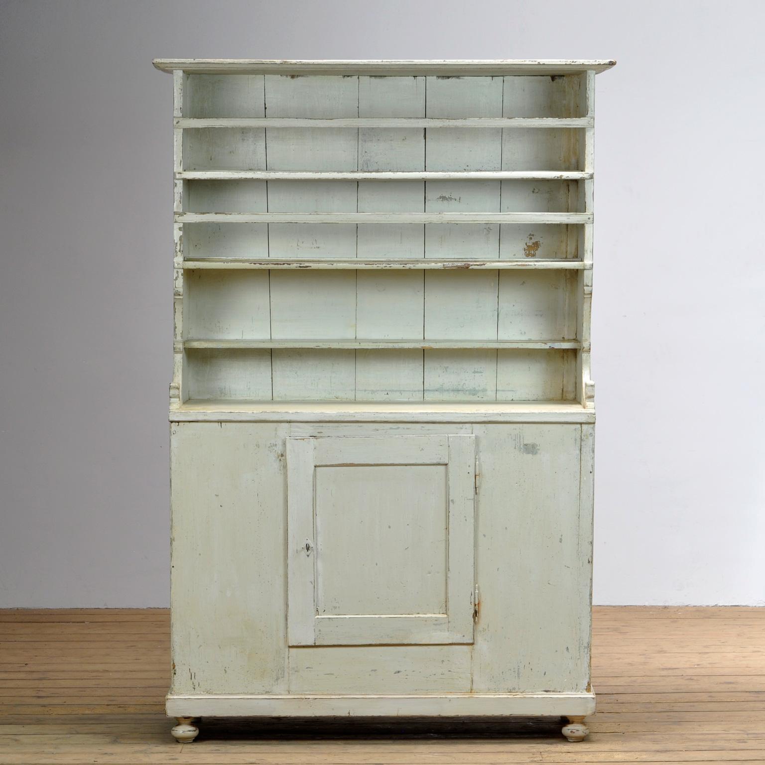Lovely vintage farmhouse dresser. Original off white paint. Open top storage to the top with three shelves. Closed cupboard storage beneath with one shelf. General wear and tear in keeping with it’s age.