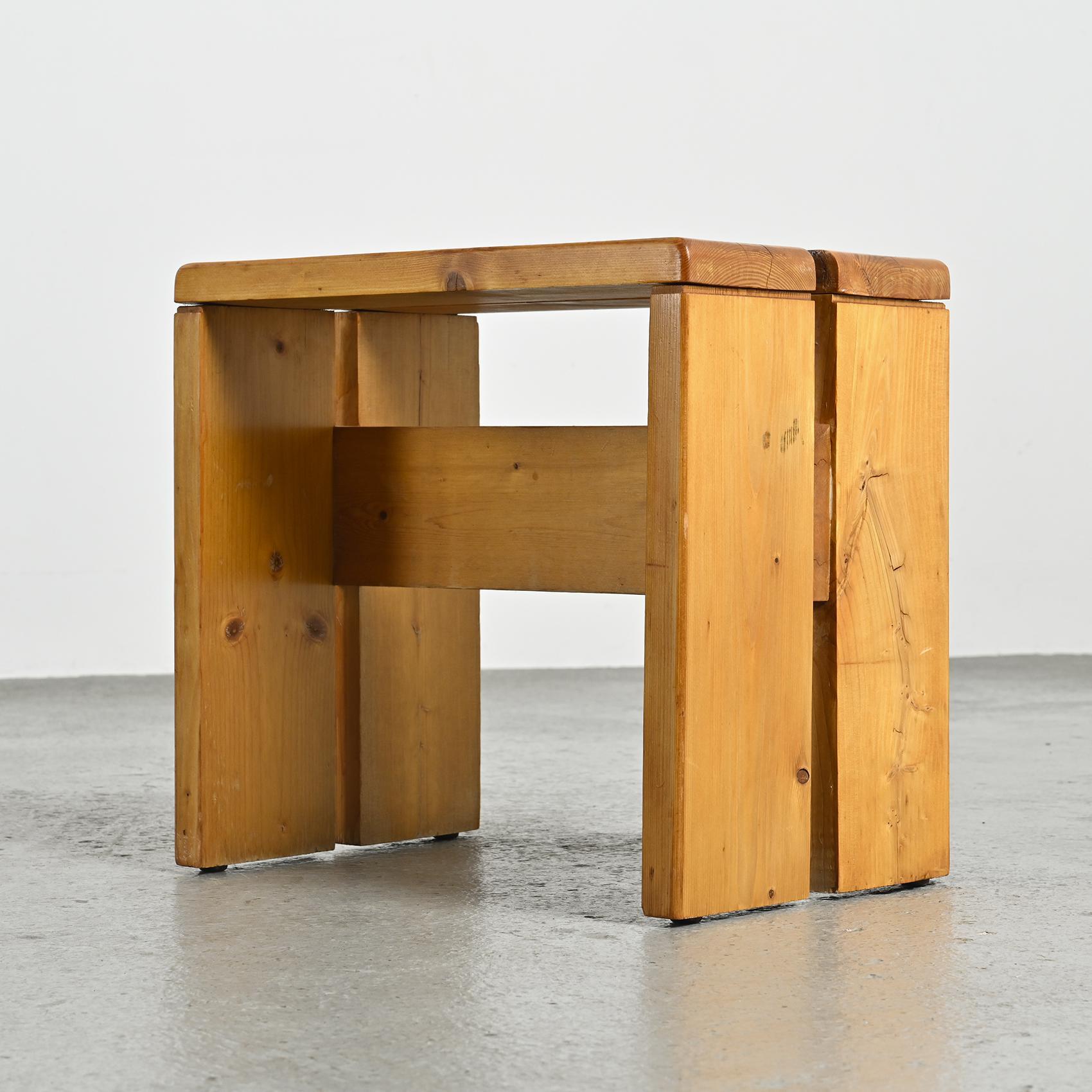 Crafted with precision from solid pine, these stools features an elegant inverted U shape and a charming patina. These stools were specifically selected as the model for the Les Arcs 1800 ski resort, where Charlotte Perriand devoted an impressive 20