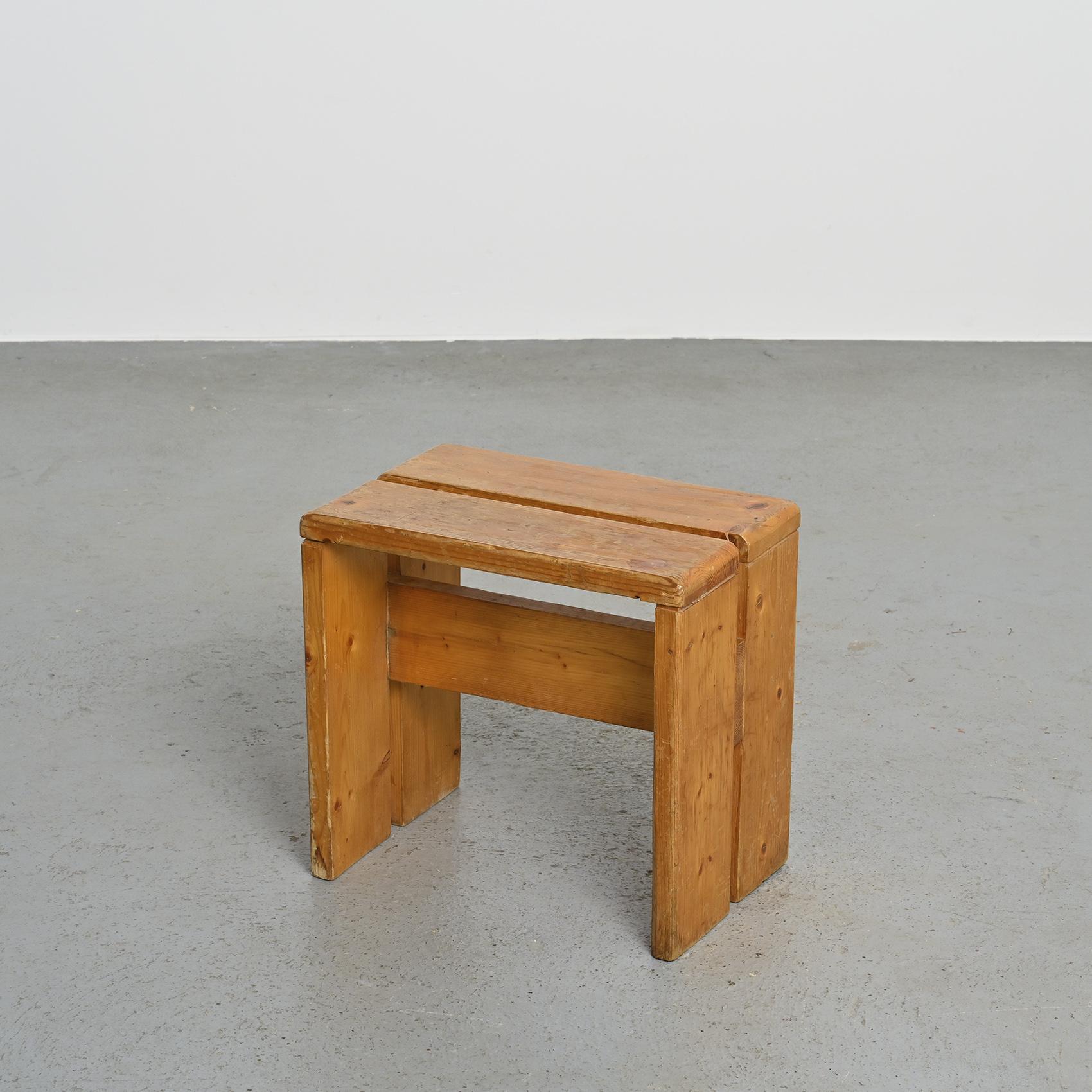 Crafted with precision from solid pine, these stools features an elegant inverted U shape and a charming patina. These stools were specifically selected as the model for the Les Arcs 1800 ski resort, where Charlotte Perriand devoted an impressive 20