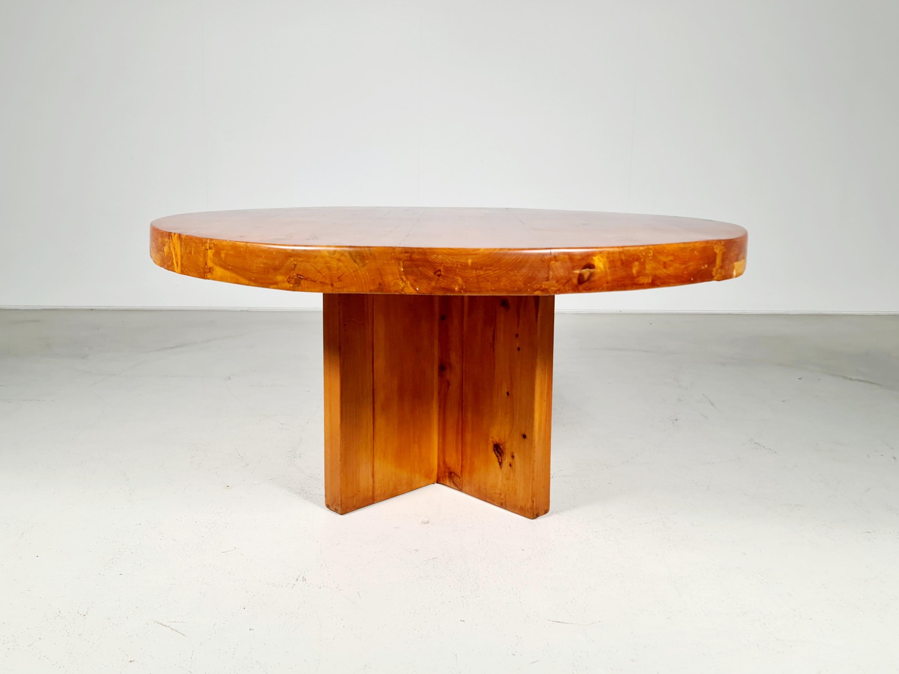 One of a kind solid pinewood wabi-sabi style dining table from the 1970s. Two cross legs lift up the solid round tabletop. In that way a strong and stable look is created. Both the legs and the top are visually structured by the natural grain of the