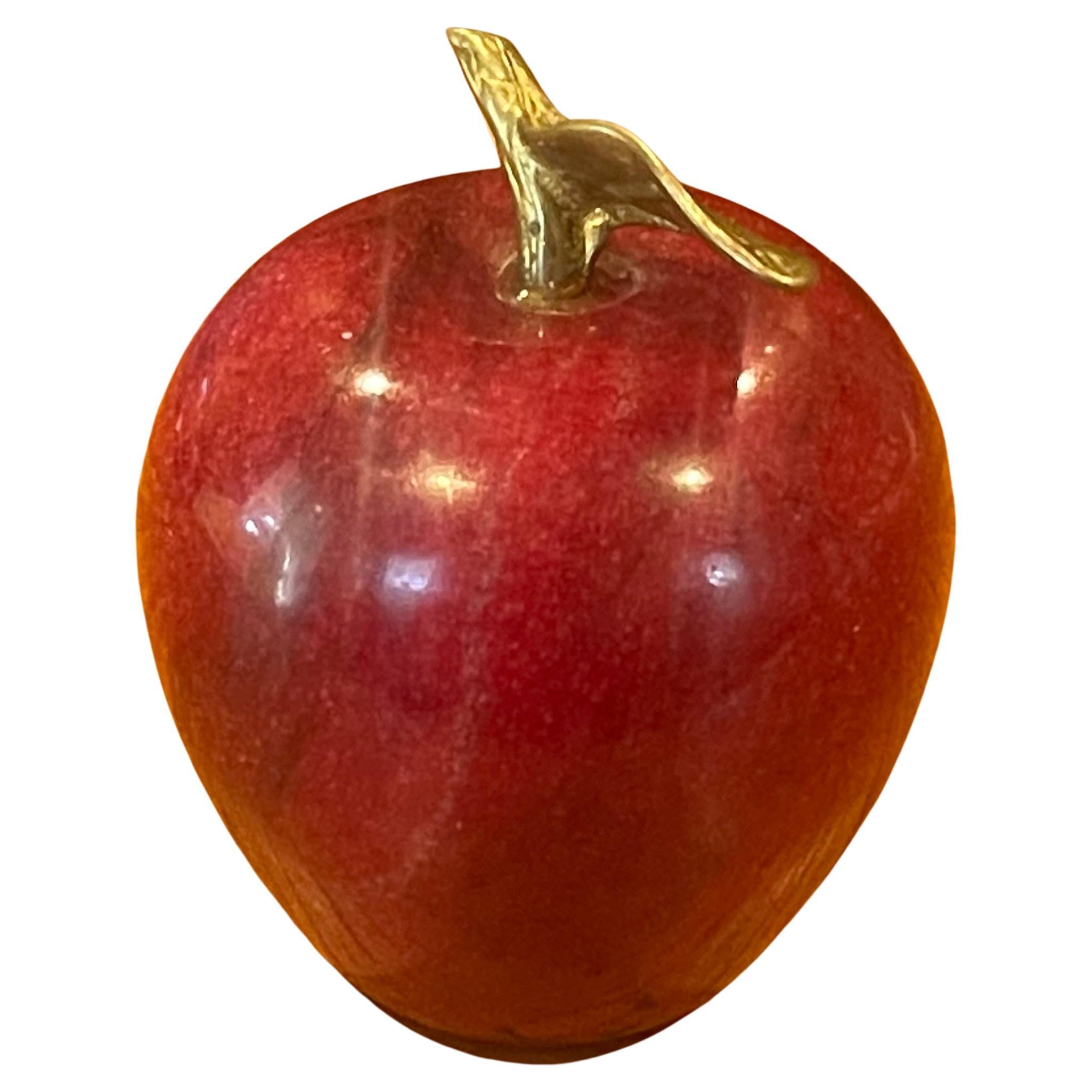 Solid red marble with brass accent stem apple paperweight or sculpture, circa 1970s. The piece is in very good vintage condition with no chips or cracks and measures 3