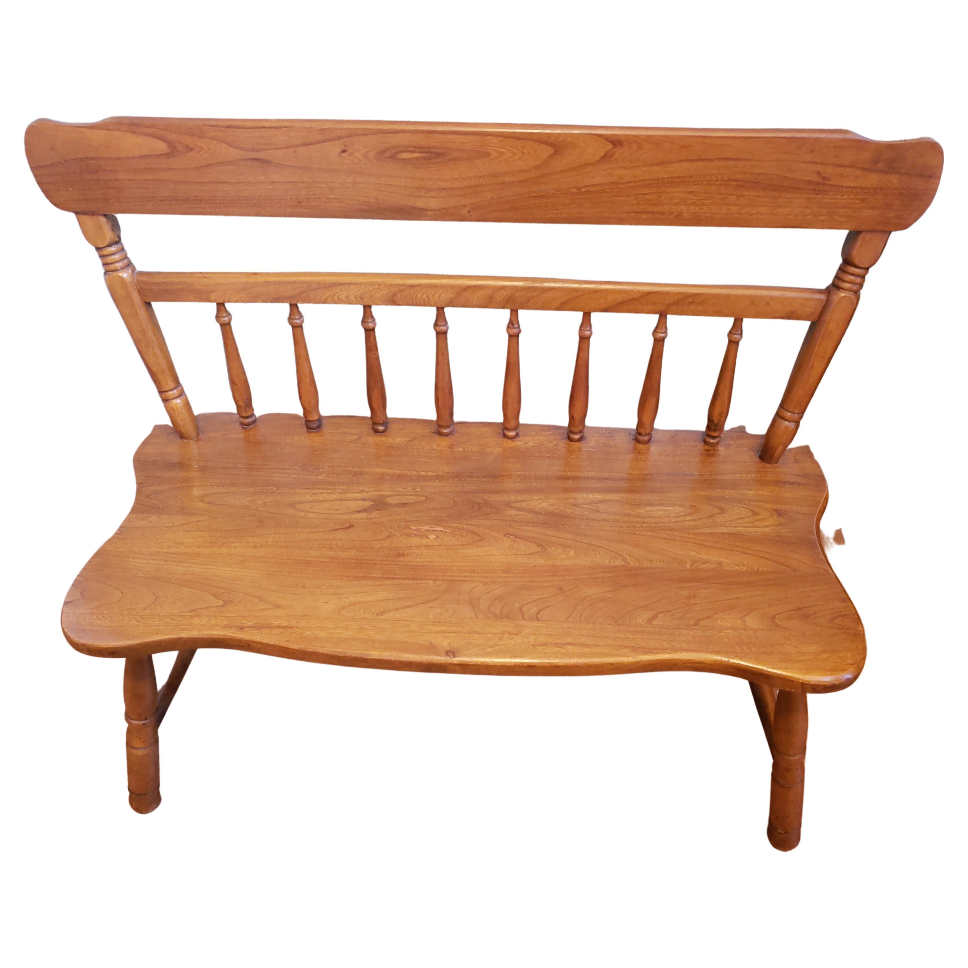 Solid wood farmhouse style bench or settee with carved spindle and ladder back and beautifully turned legs. This is an heirloom quality piece that will last for generations! At 37