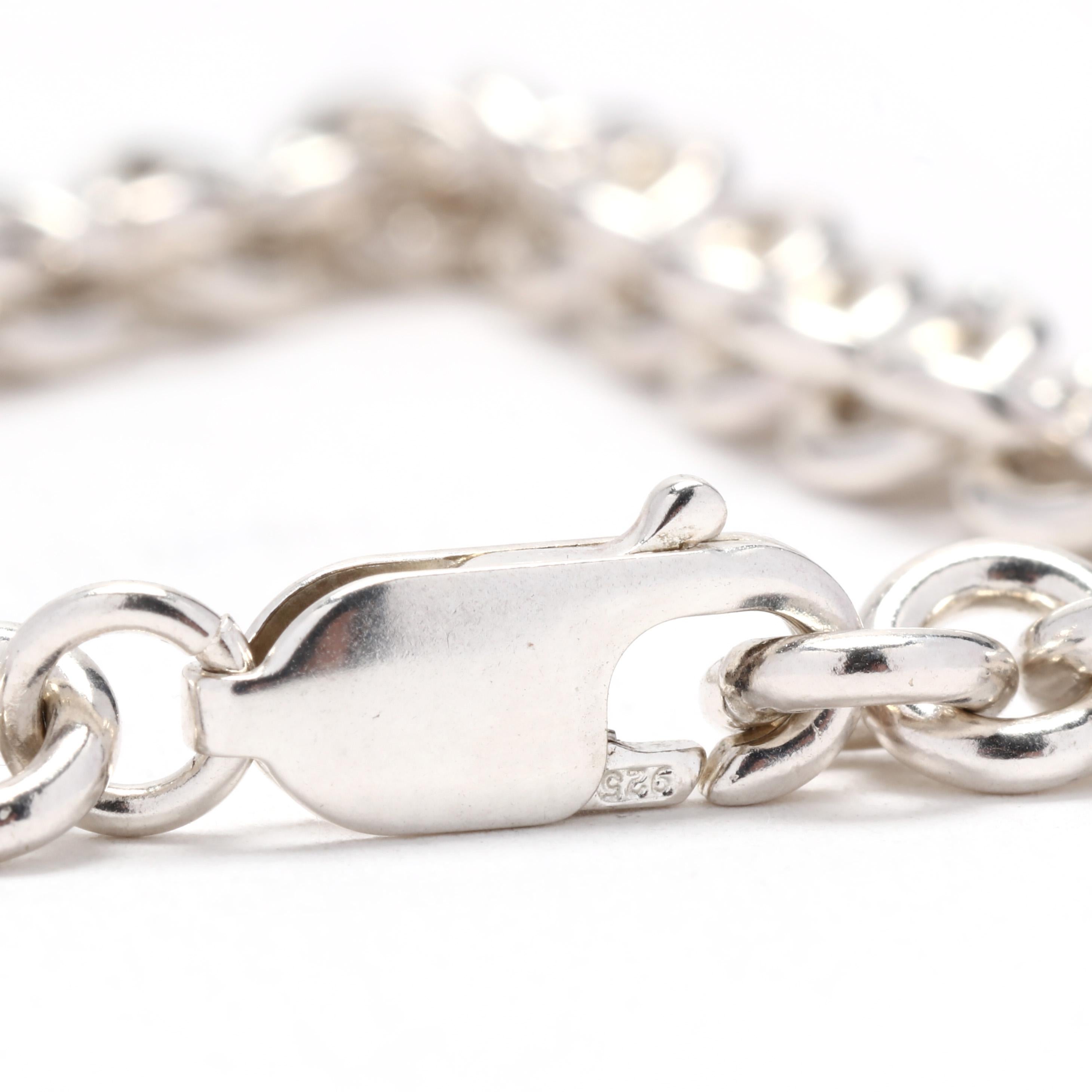 A sterling silver rolo link chain bracelet.  This bracelet is comprised of round link rolo chain links and completed with a lobster clasp.  It is stamped 925.

Length: 7 3/8 inches

Width: 1/4 inch

Weight: 9.6 dwt / 14.8 grams

Metal: Sterling