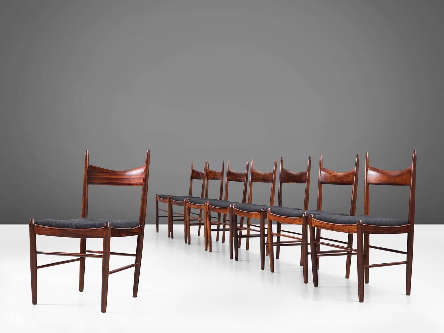 Set of eight dining chairs, in rosewood and fabric, attributed to Illum Wikkelsø for Vestervig Eriksen, Denmark, 1950s. 

This unique set of eight rosewood dining chairs in black leather upholstery with elegant details, attributed to Illum