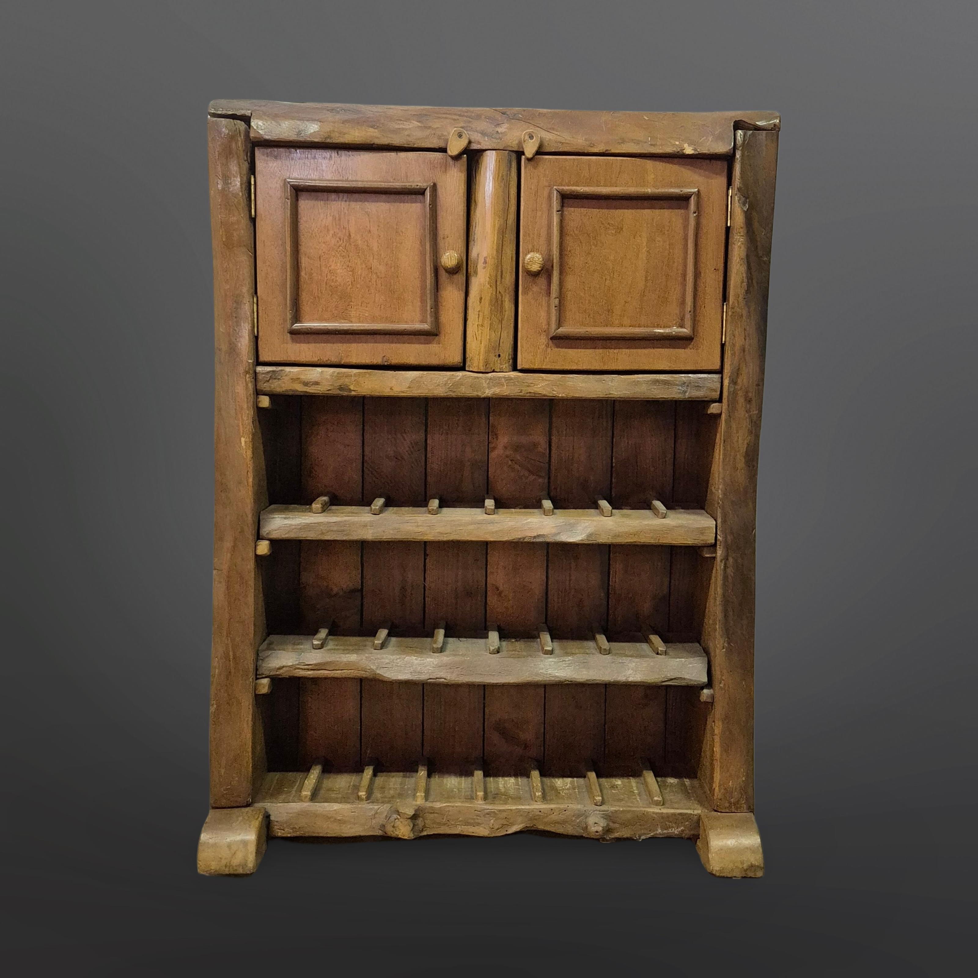 this handcrafted dry bar was made in France in the 1950s. Made from solid oak. the natural shape of the wood has been retained and the design has been adapted to the irregular shape of the wood. It has a storage space for glasses with 2 doors. 
The