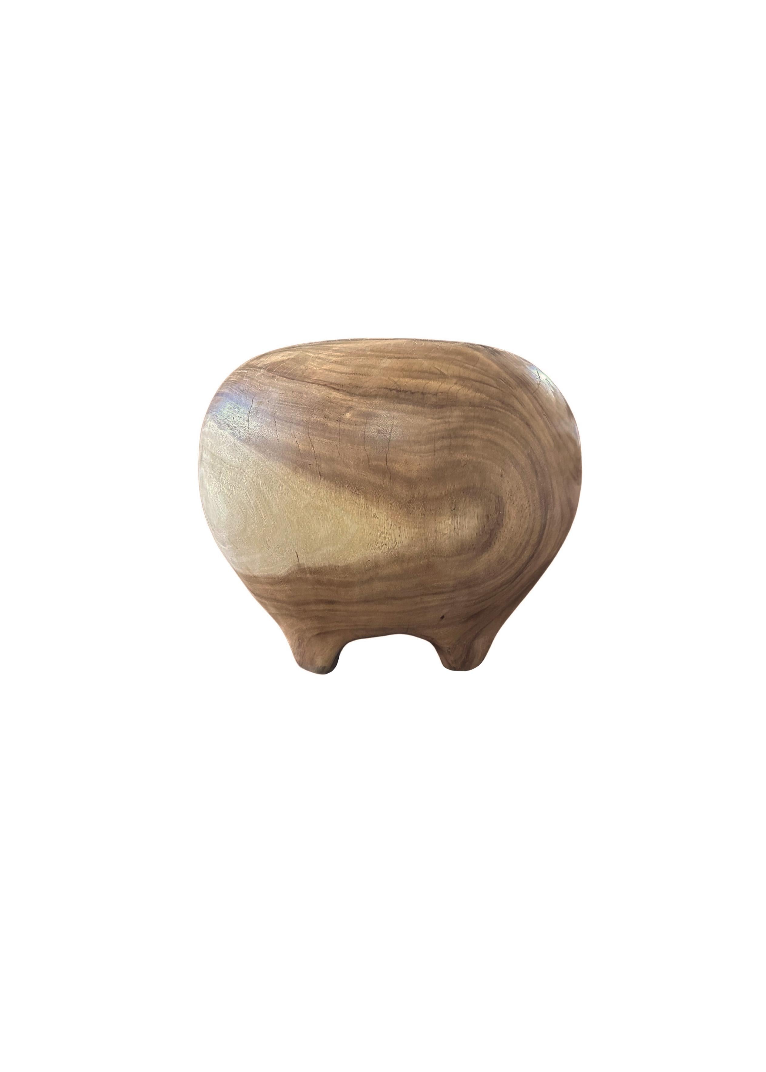 A wonderfully organic round side table that sits on 6, low, arched legs that blend with its form. Its neutral pigment and subtle wood texture makes it perfect for any space. This table was crafted from a solid trunk of mango wood. The table was