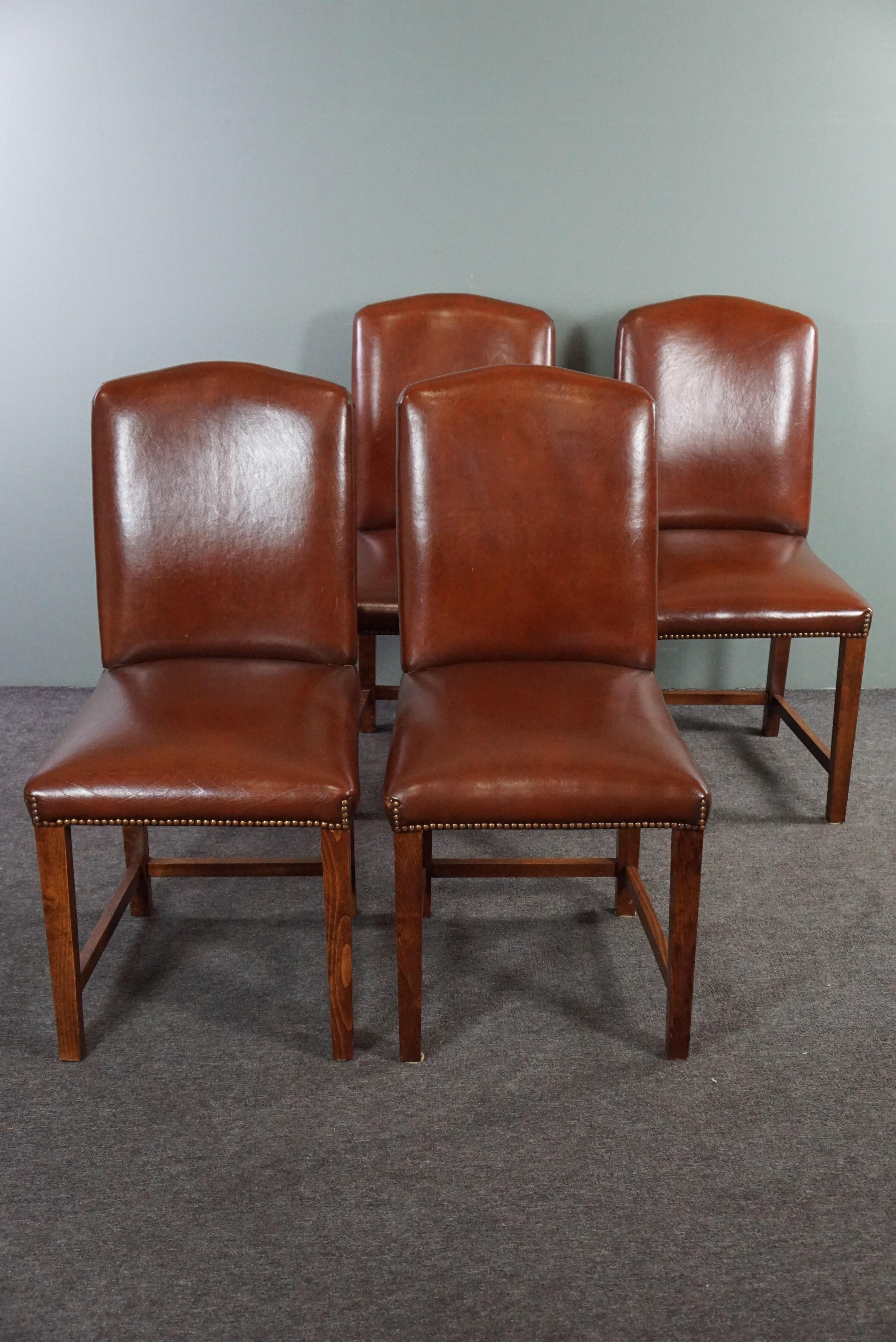 Offered is this subtle set of 4 beautiful classic dining room chairs finished with decorative nails.

This very good quality and solid set of 4 dining room chairs have a calm and sleek design, good seating comfort and a beautiful sheep leather seat