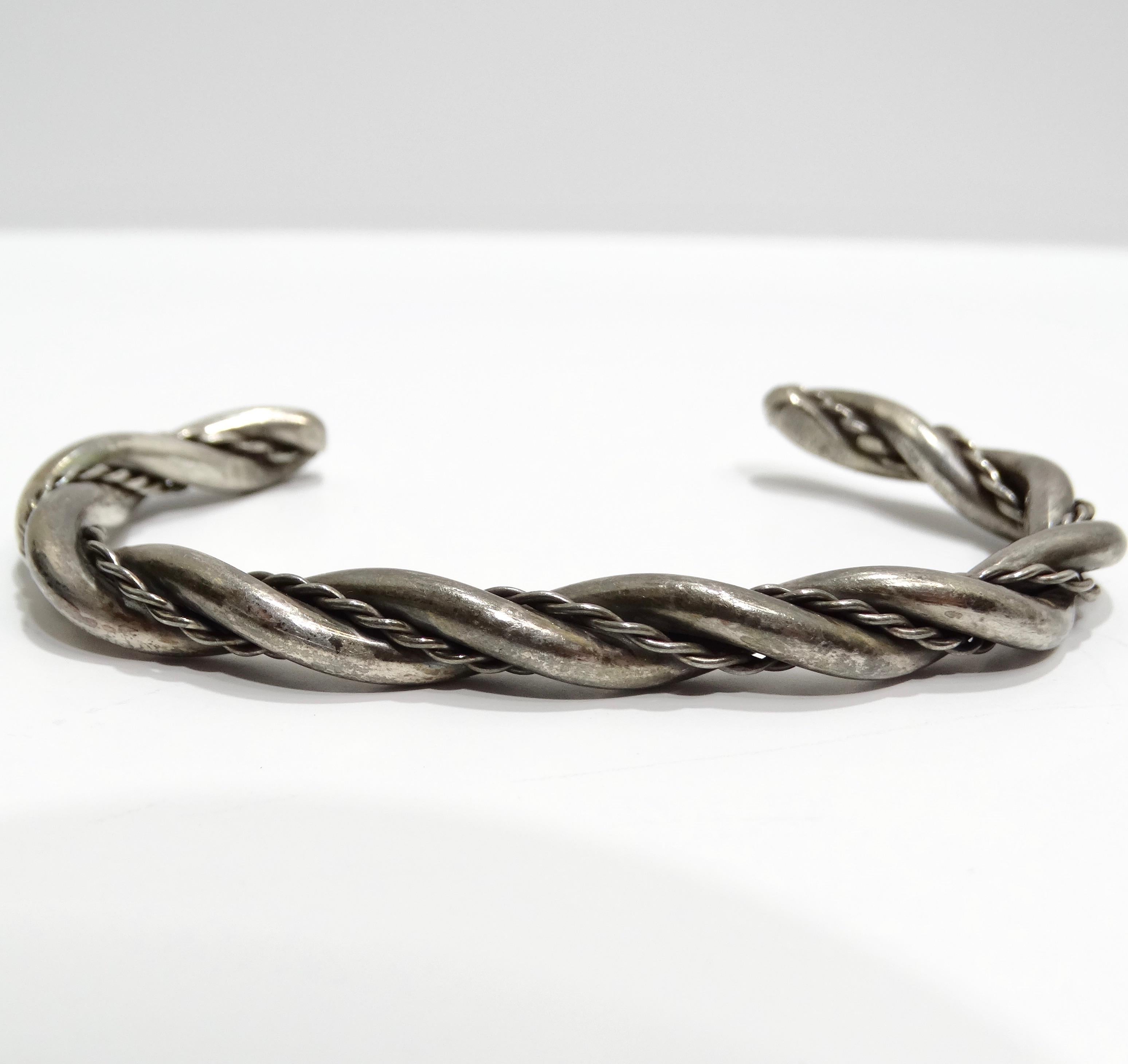 Introducing the Solid Silver 1960s Rope Cuff Bracelet, a beautiful and timeless piece that adds a touch of classic elegance to any jewelry collection. This cuff bracelet is crafted from pure silver and features a unique rope motif, creating a