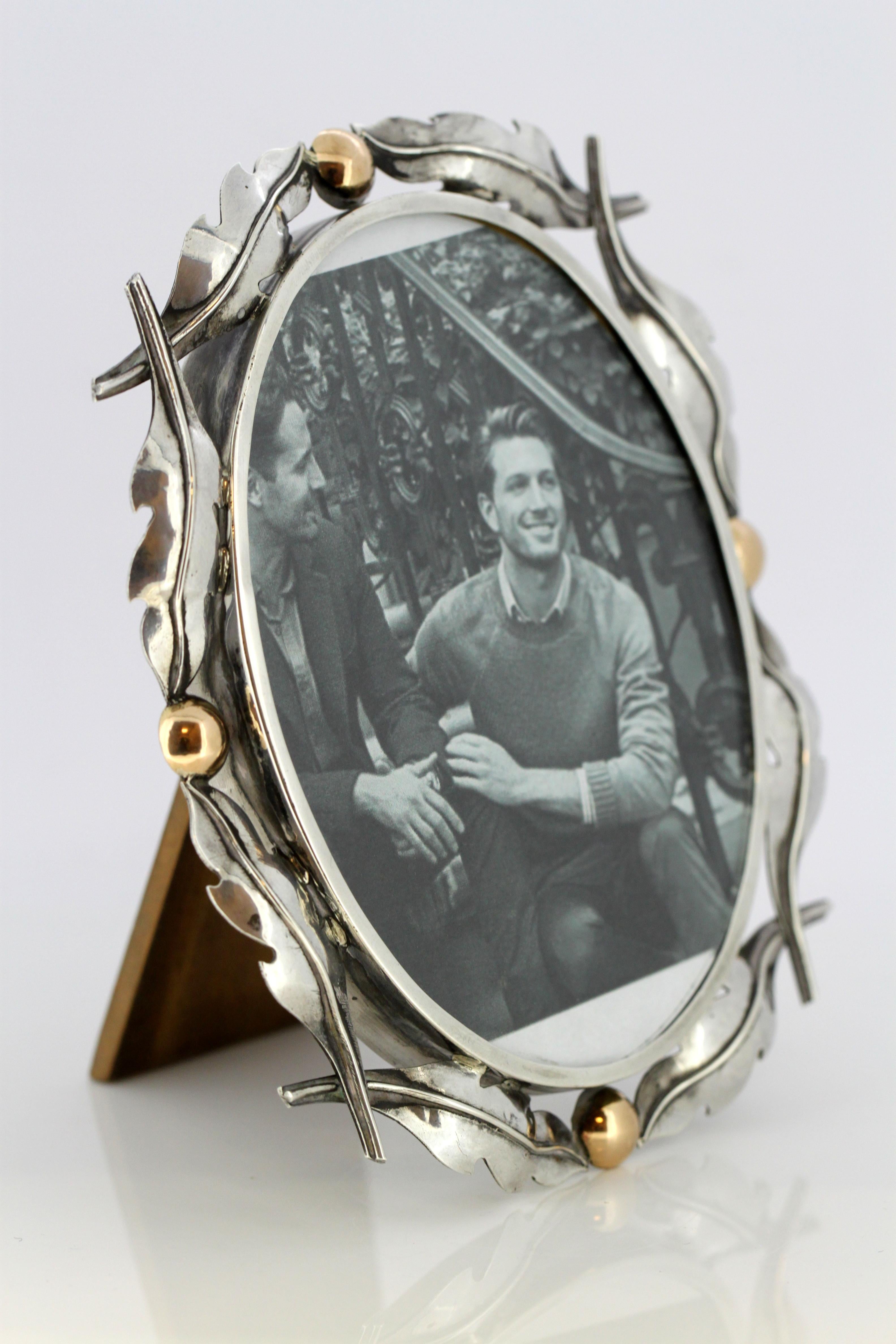 Solid silver and 14-karat gold picture frame
Made in Europe , circa 1920s-1930s
Tested positive for silver and gold.

Size: Height 13.5 cm, width 12 cm, depth 1.5 cm

Weight: silver frame 64 grams, with glass: 165 grams
Condition: General