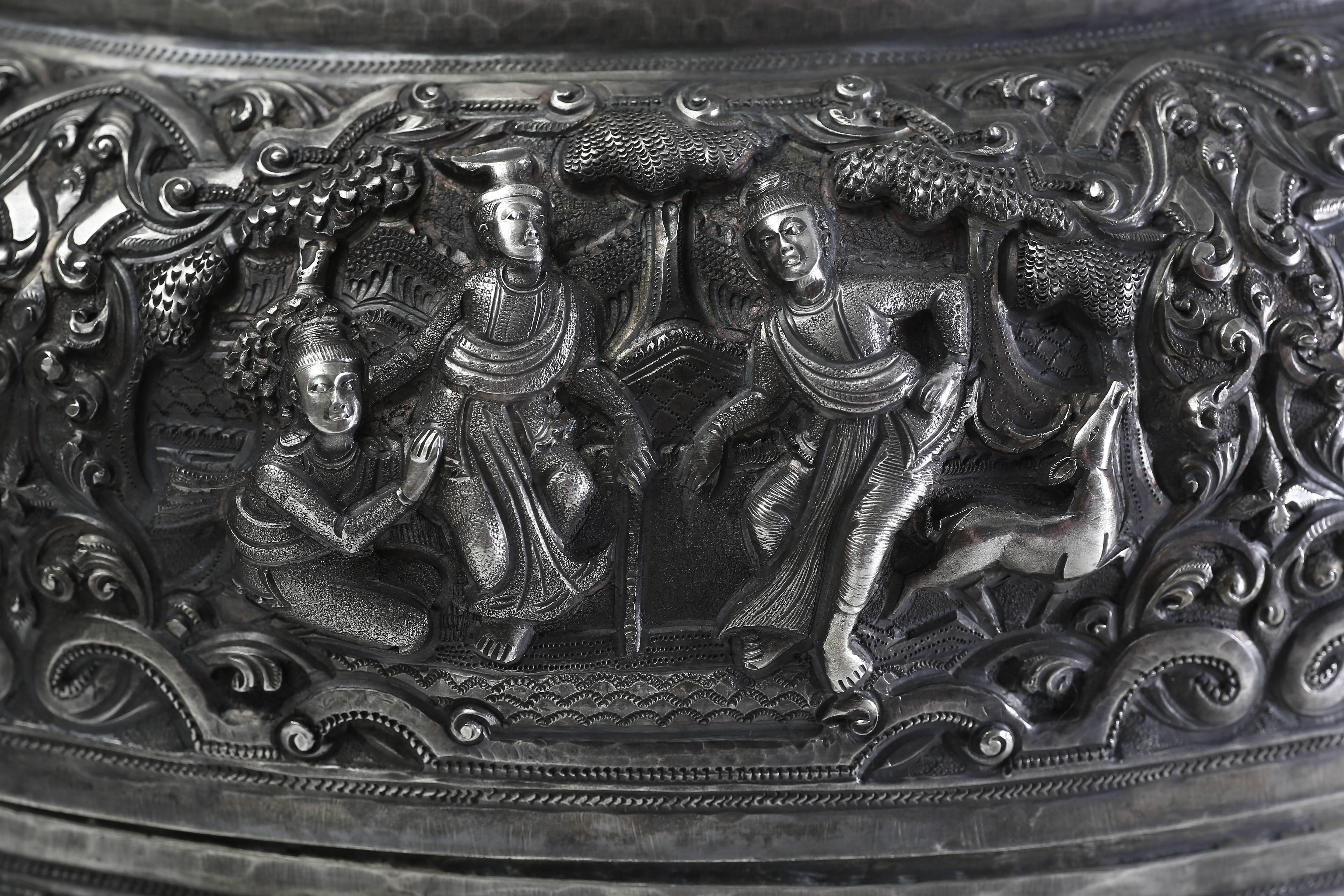 The exquisite offering vessel is finely cased with Jataka scenes in high relief.
Offering vessels, one of the most graceful of ceremonial objects, were reserved for religions use. Covered vessels of this type were traditionally used to carry