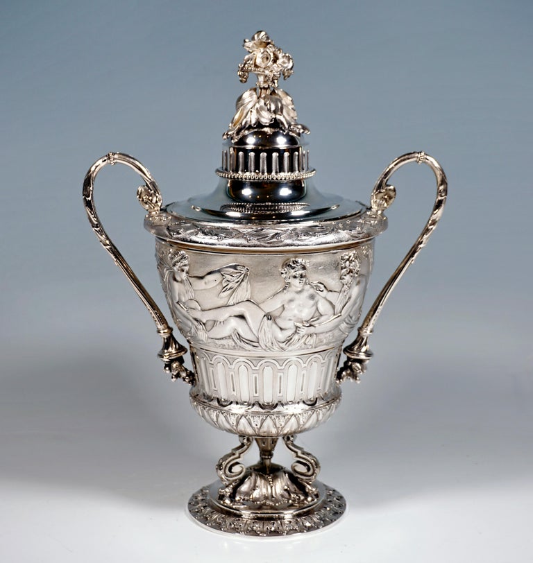Solid silver goblet, widening conically upwards, on a separate base with acanthus leaf decoration, supported by acanthus leaf chapter and three volute feet with horse hooves, vessel with floral and stylized decorative bands and surrounding frieze
