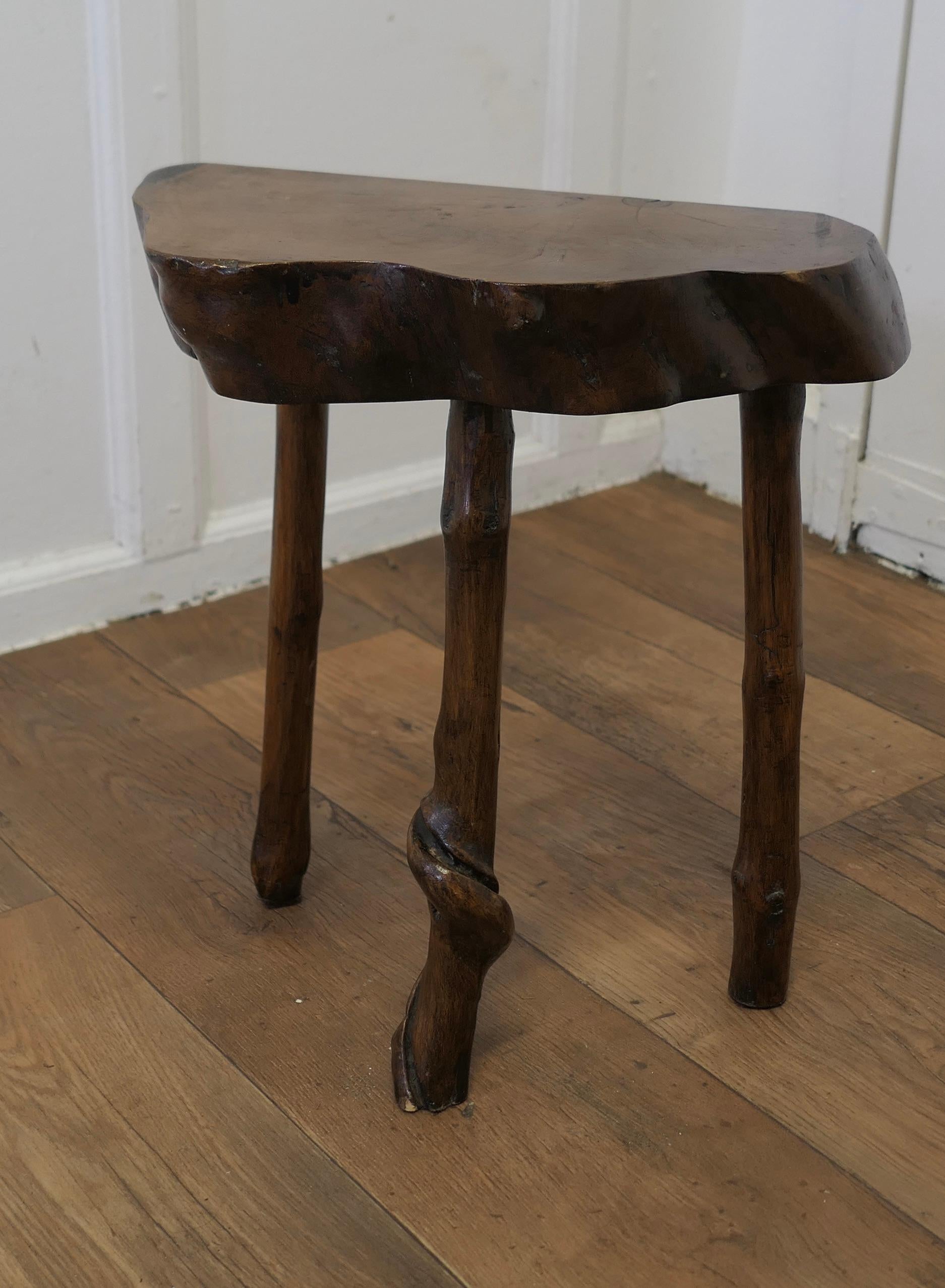 Solid Slice of Live Edge Elm Rustic Stool

A slice of elm cut from one piece of the Tree, flat with a live edge and uneven shape, the legs are made from twisted wood which formed by allowing vines to grow around the wood while it is growing 
 
The