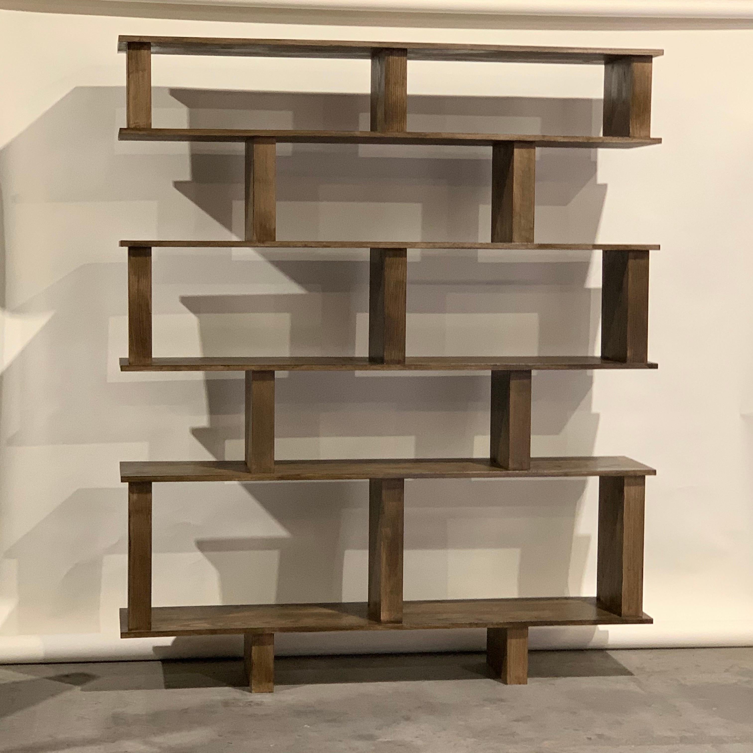 Solid stained red oak verticale shelving unit by Design Frères. Comes in 3 easy to transport and assemble elements.