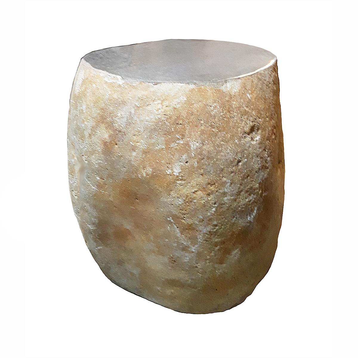 A solid stone end table, stool or stand with textured sides and polished top. From Indonesia, contemporary. Oblong shape. Ideal accent table for an indoor organic decor, as a garden addition, or as a stand.