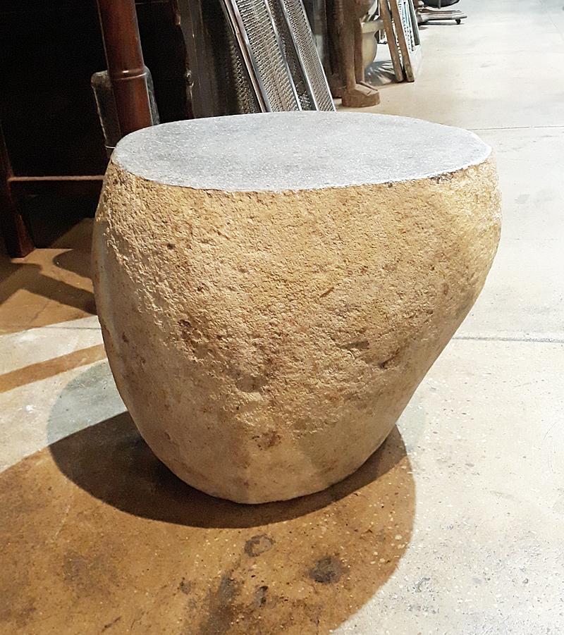 A solid stone end table, stool or stand with textured sides and polished top. From Indonesia, contemporary. Oblong shape. Ideal accent table for an indoor organic decor, as a garden element, or as a heavy, sturdy stand anywhere. 


