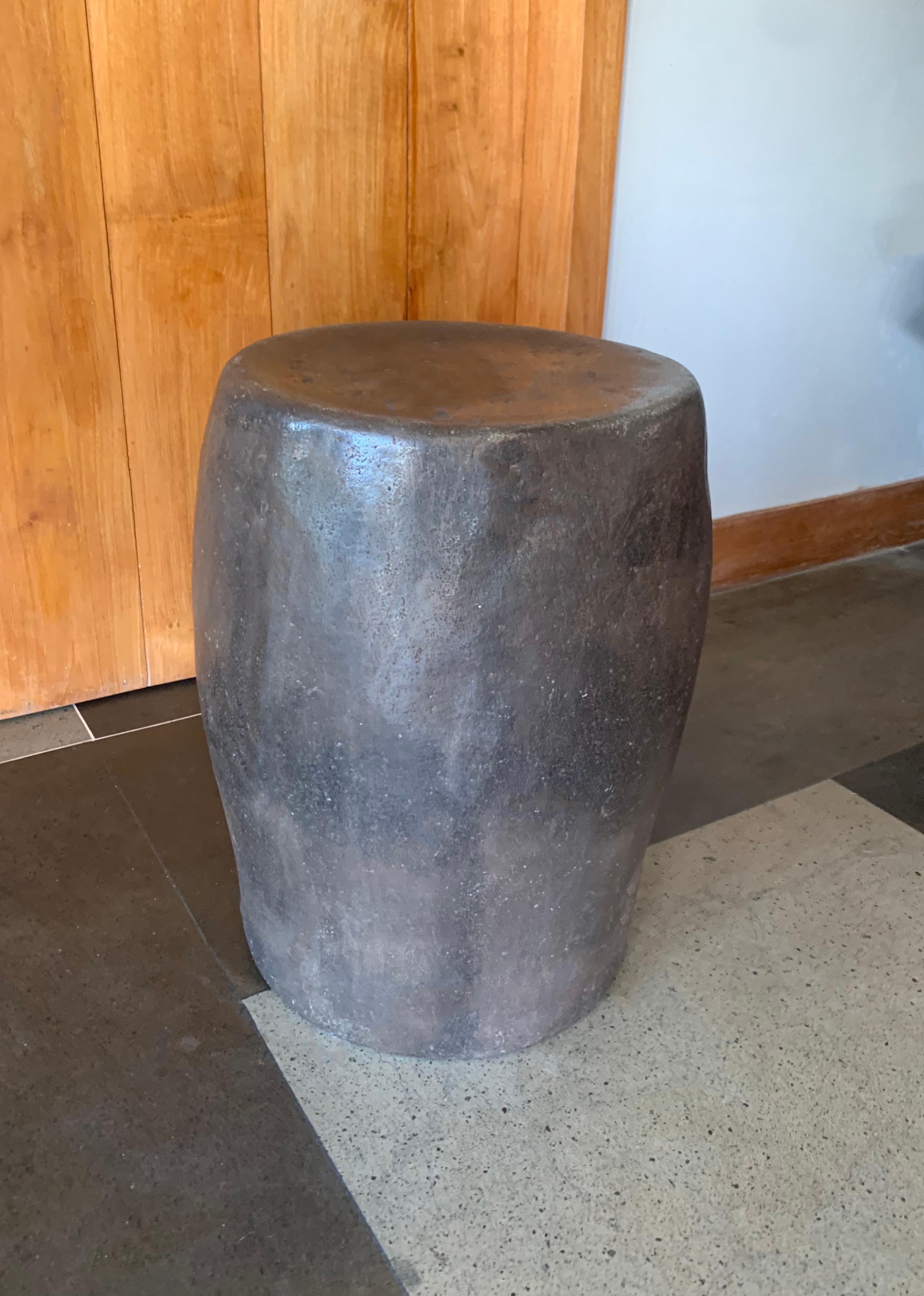 A incredibly heavy and solid rounded stone block. This lovely sculptural object was crafted from a solid stone slab. A raw and organic object with beautiful textures. Sourced from a river bed in East Java, it was carefully shaped and polished into