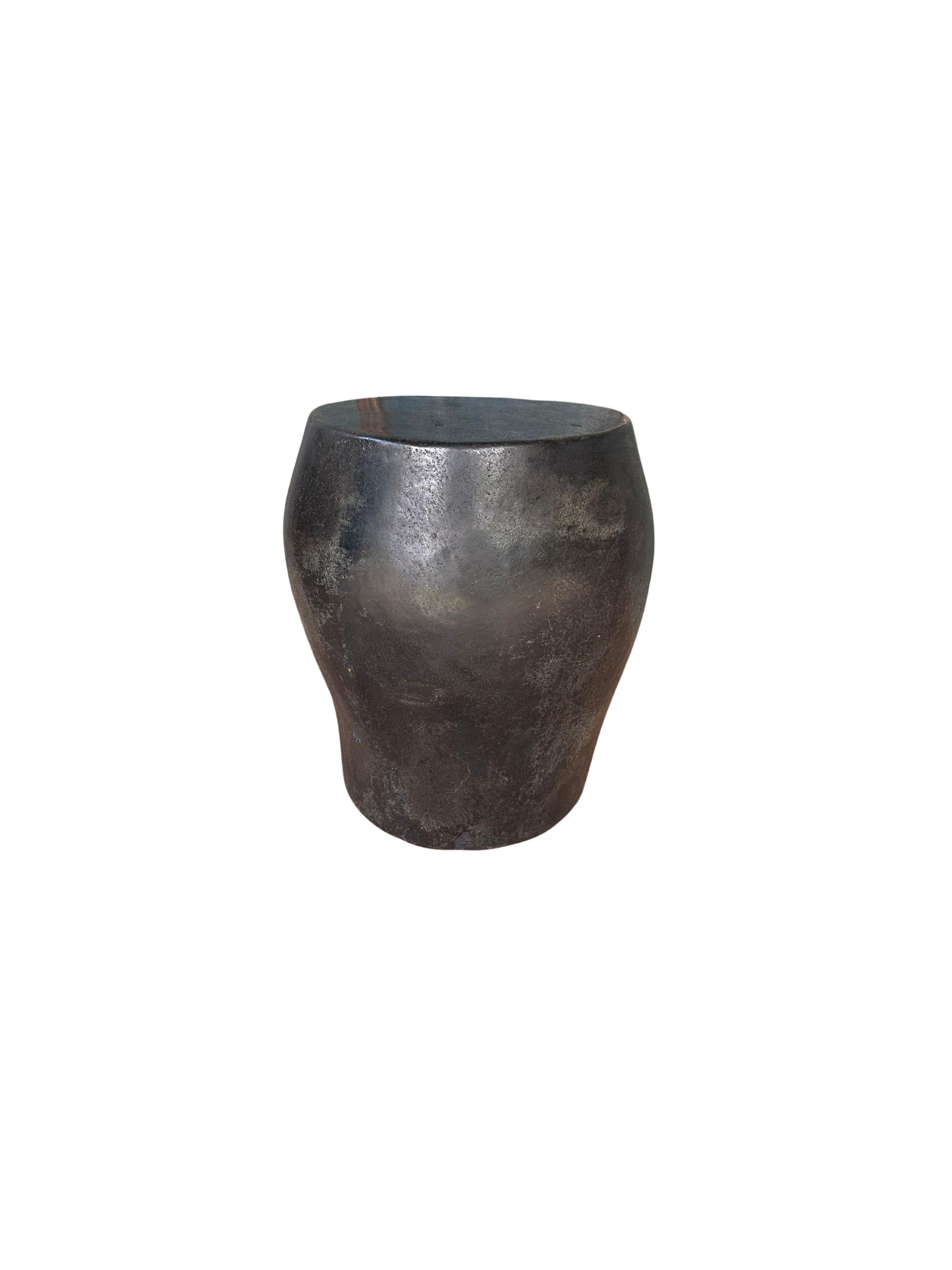 A incredibly heavy and solid rounded stone block. This lovely sculptural object was crafted from a solid stone slab. A raw and organic object with beautiful textures. Sourced from a river bed in East Java, it was carefully shaped and polished into
