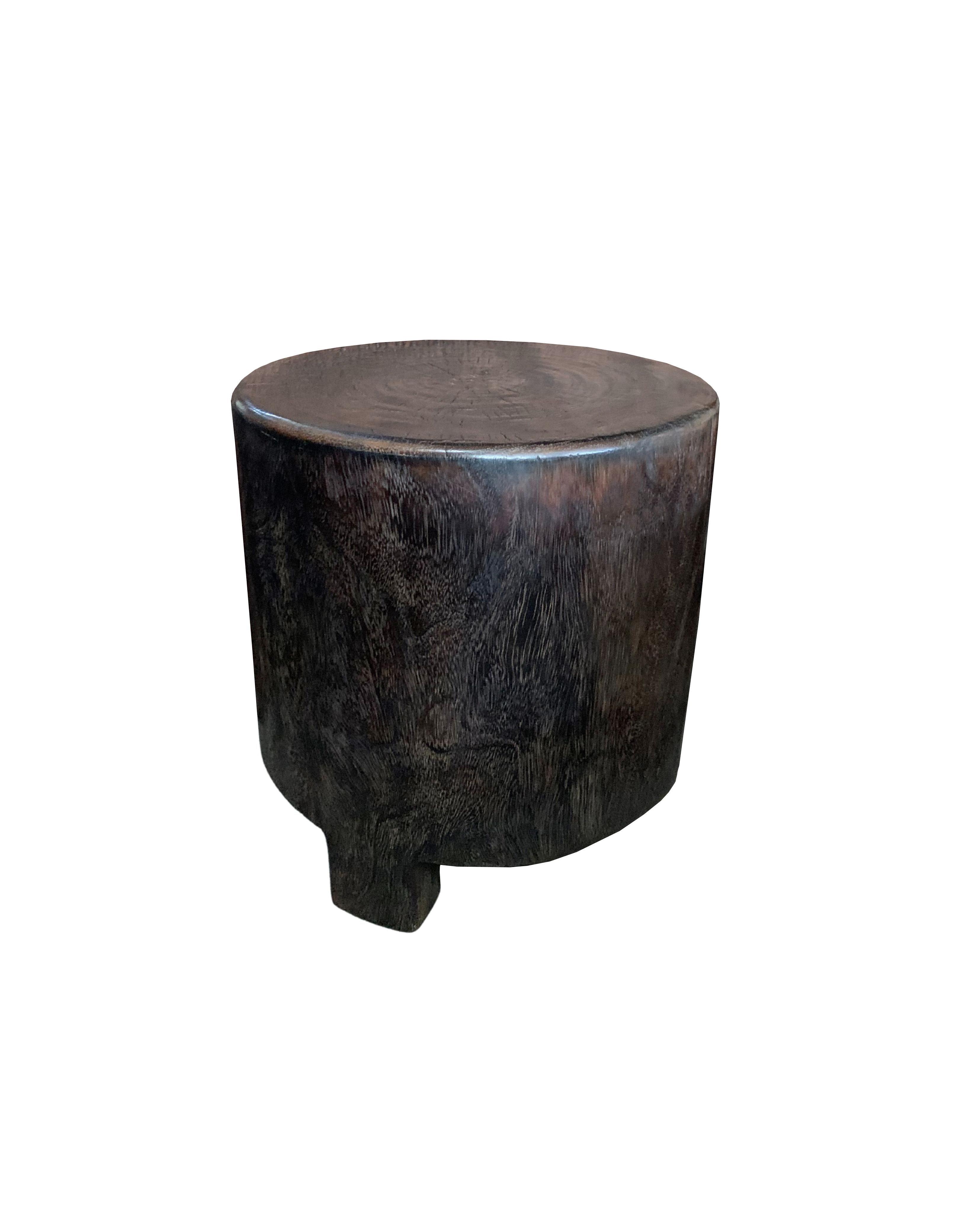 A wonderfully sculptural round side table. Its neutral pigments make it perfect for any space. A uniquely sculptural and versatile piece certain to invoke conversation. It was crafted from a solid block of suar wood and has a smooth texture finish.