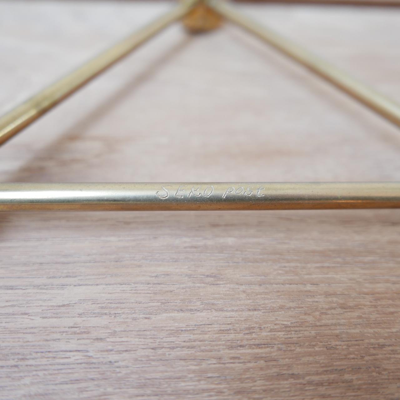 A solid brass candlestick, three arms in triangular form. 

Elegant form, good quality, perfect for a table top. 

Sweden, late 20th century. 

Stamped Gusum. Also inscribed Seko Post on one arm. 

Dimensions: 20 W x 20 D x 10 H in cm.