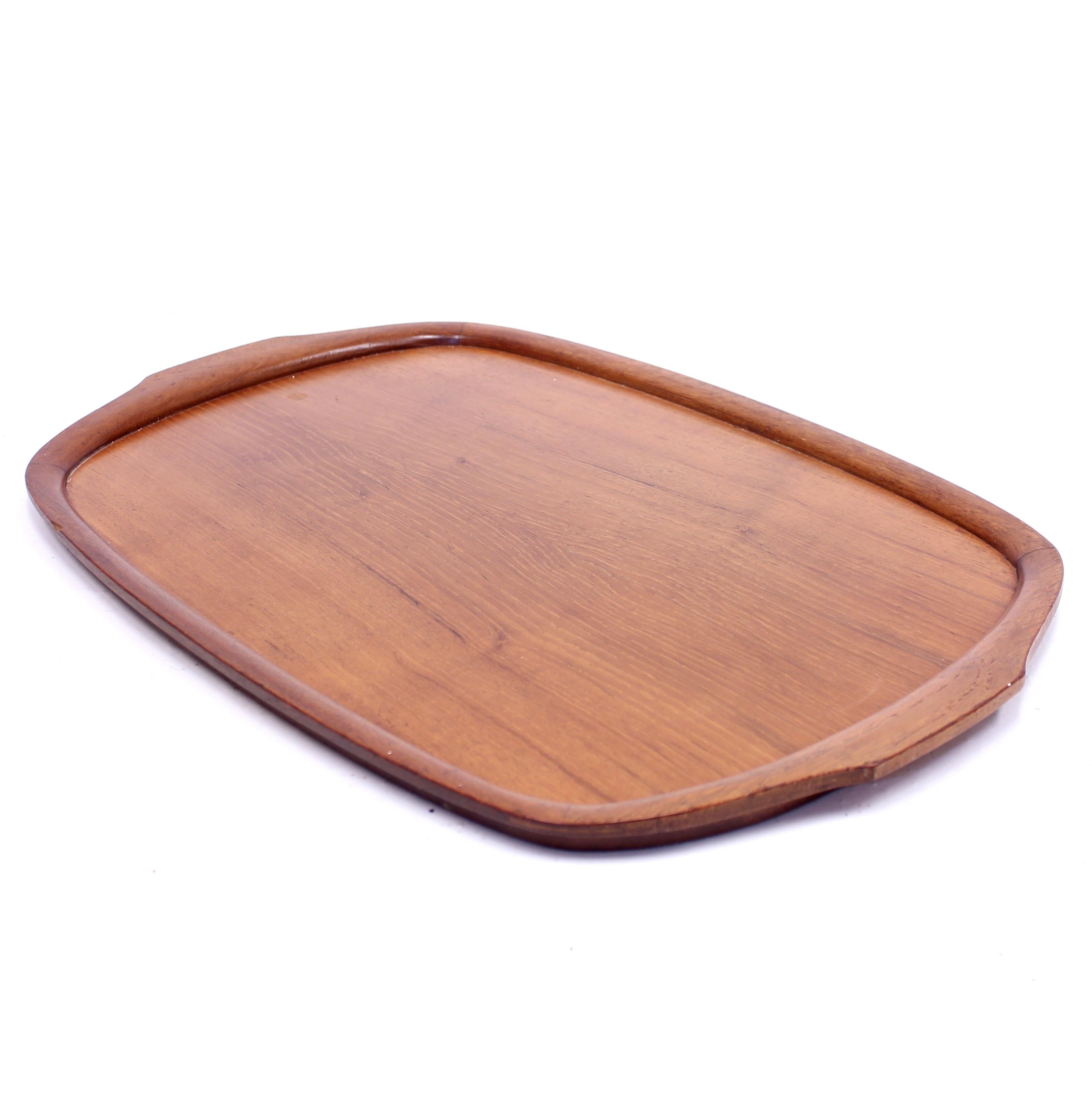 Solid Swedish teak tray produced by Karl Holmberg i Götene AB. Marked by maker with sticker on the underside. Light ware consistent with age and use.