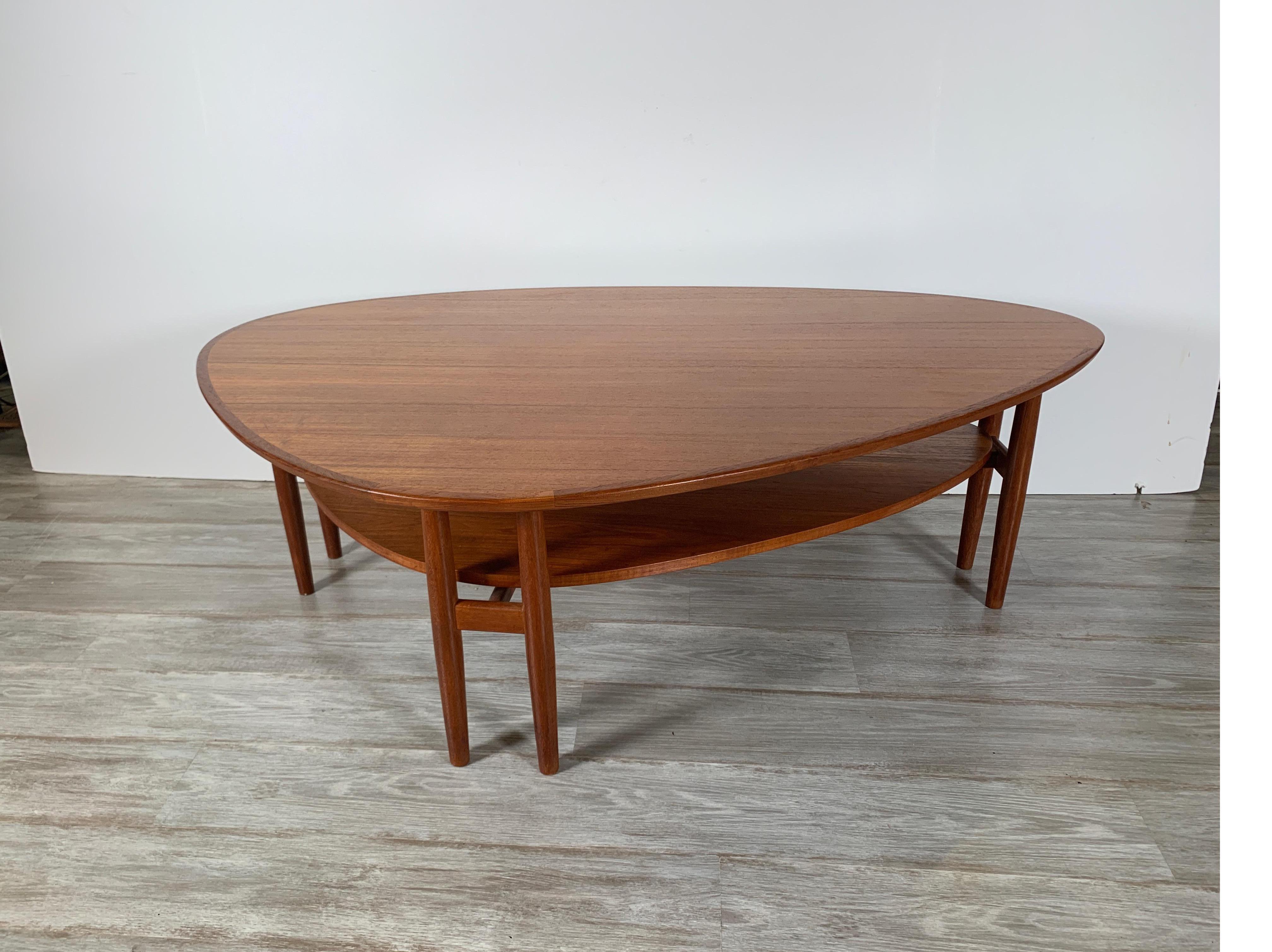 Beautiful and uncommon asymmetric coffee table in solid teak with unique double legged form by Arne Vodder for Sibast, Denmark, 1960s. In beautiful unrestored original condition with only minor signs of age and use. A lovely and striking piece which