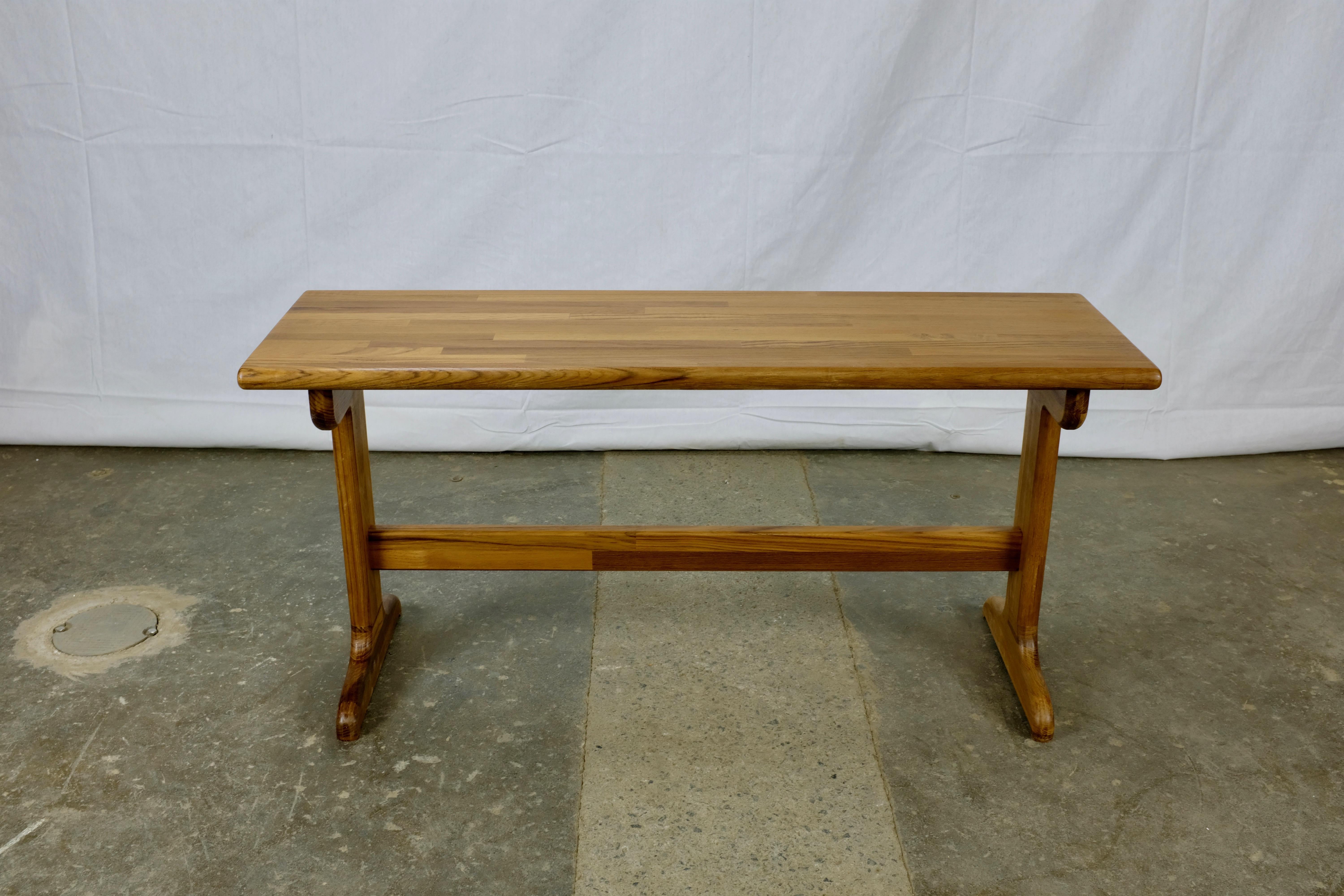Solid teak bench designed by Zvi Gross, mostly Danish furniture. Inspired by the classics of the Danish modern style, this piece features a laminated solid teak top and a trestle base that is very sturdy but does not add a great deal of visual