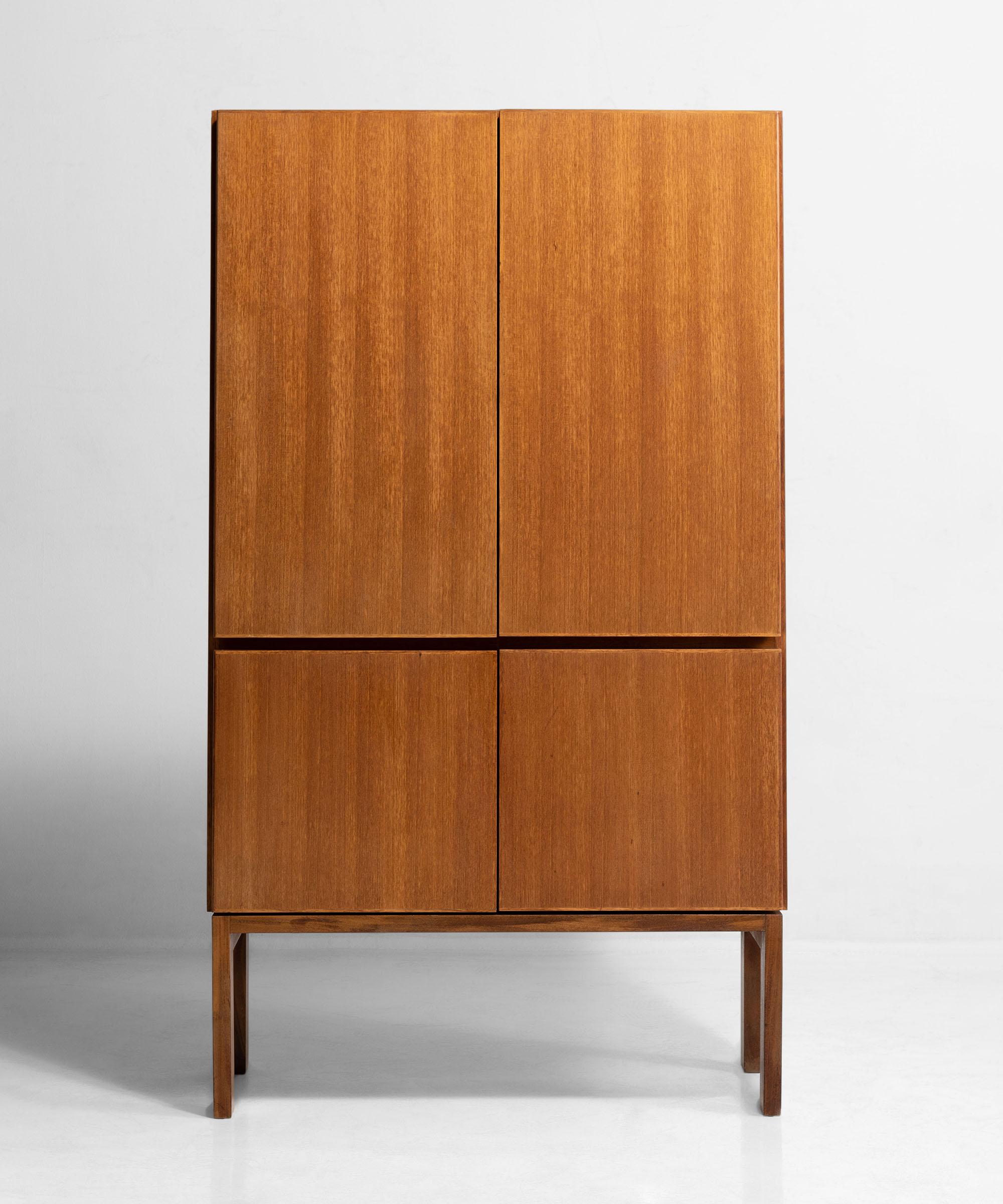 Model “GR69” four door cabinet with interior shelving on simple straight legs.
