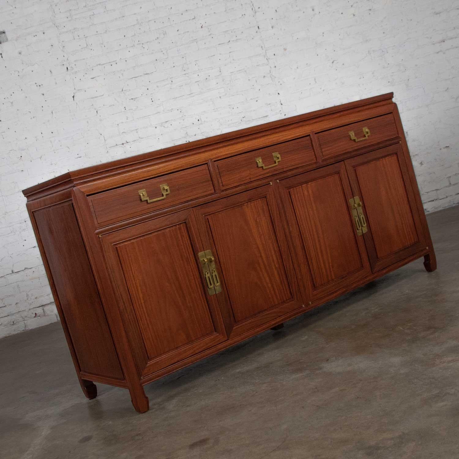 Handsome solid teak chinoiserie Hollywood Regency buffet or credenza in the style of George Zee. It is in fabulous vintage condition. It has no outstanding flaws that we have detected. It does have some small age appropriate dings on its top. Please