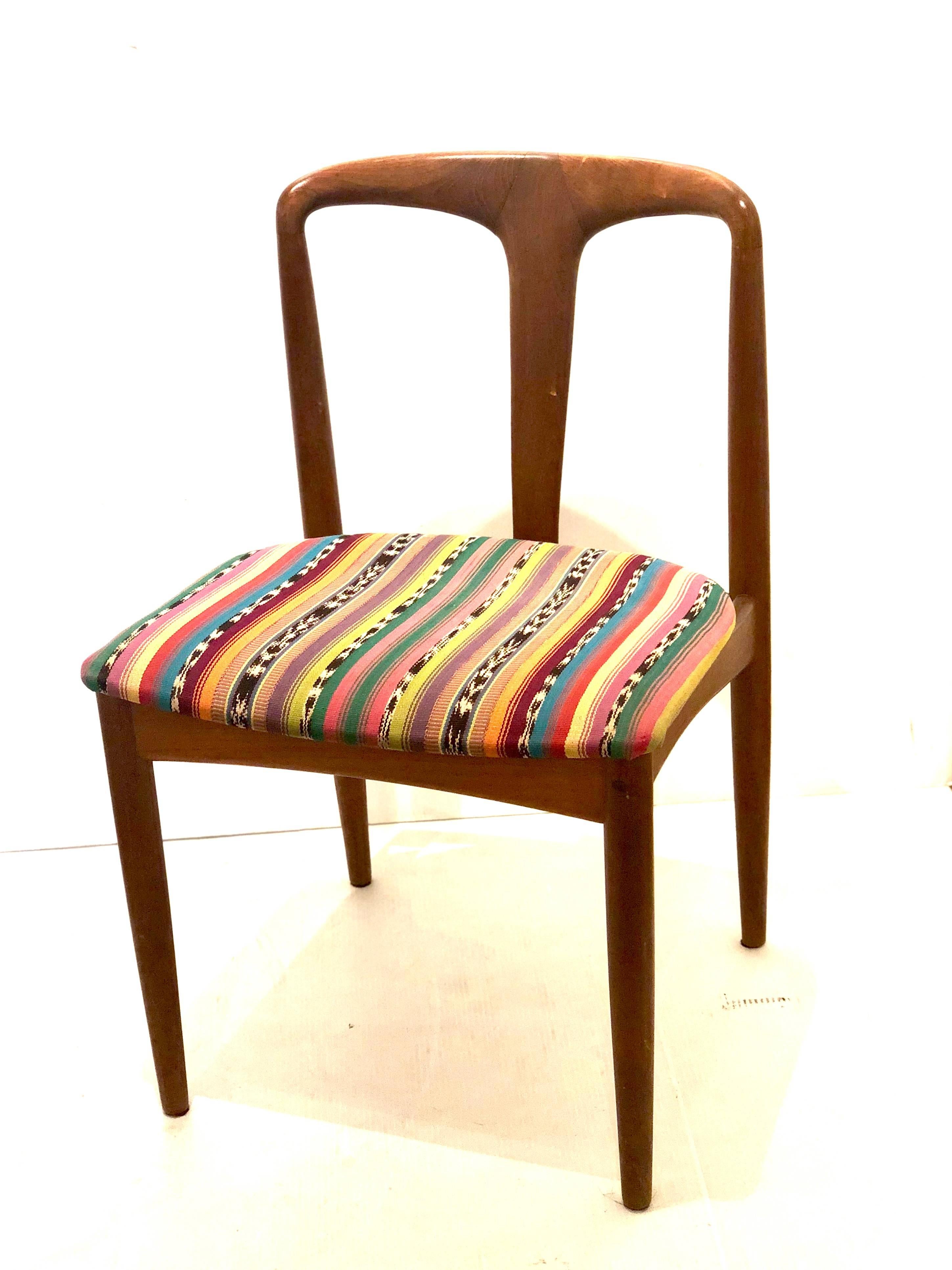 Beautiful solid sculpted teak chair designed by Johannes Andersen for Uldum Mobelfabrik, circa 1950's, nice and solid construction beautiful lines freshly refinished and recover in Mexican textile.