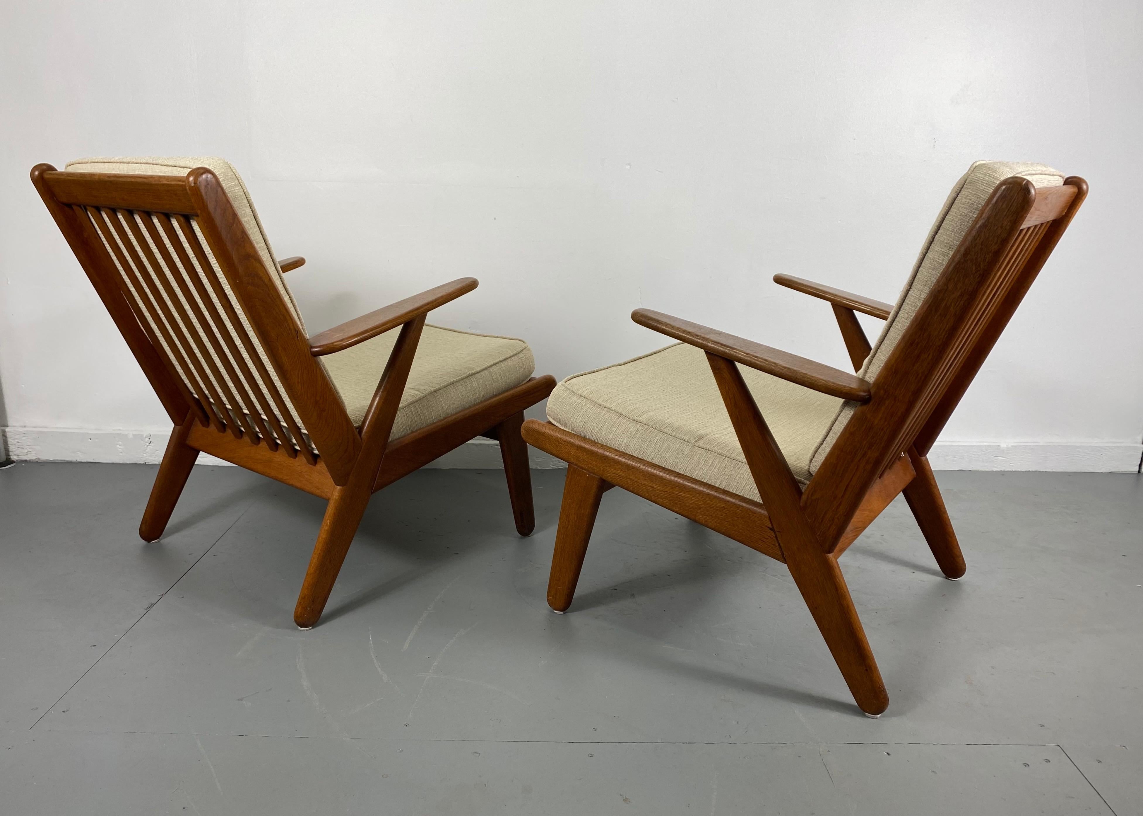 Solid teak Danish modernist lounge chairs designed by Poul Volther, Classic Scandinavian design, solid teak wood, superior quality and construction, retain original finish / patina, off white wool fabric cushions, re-strapped at some point,