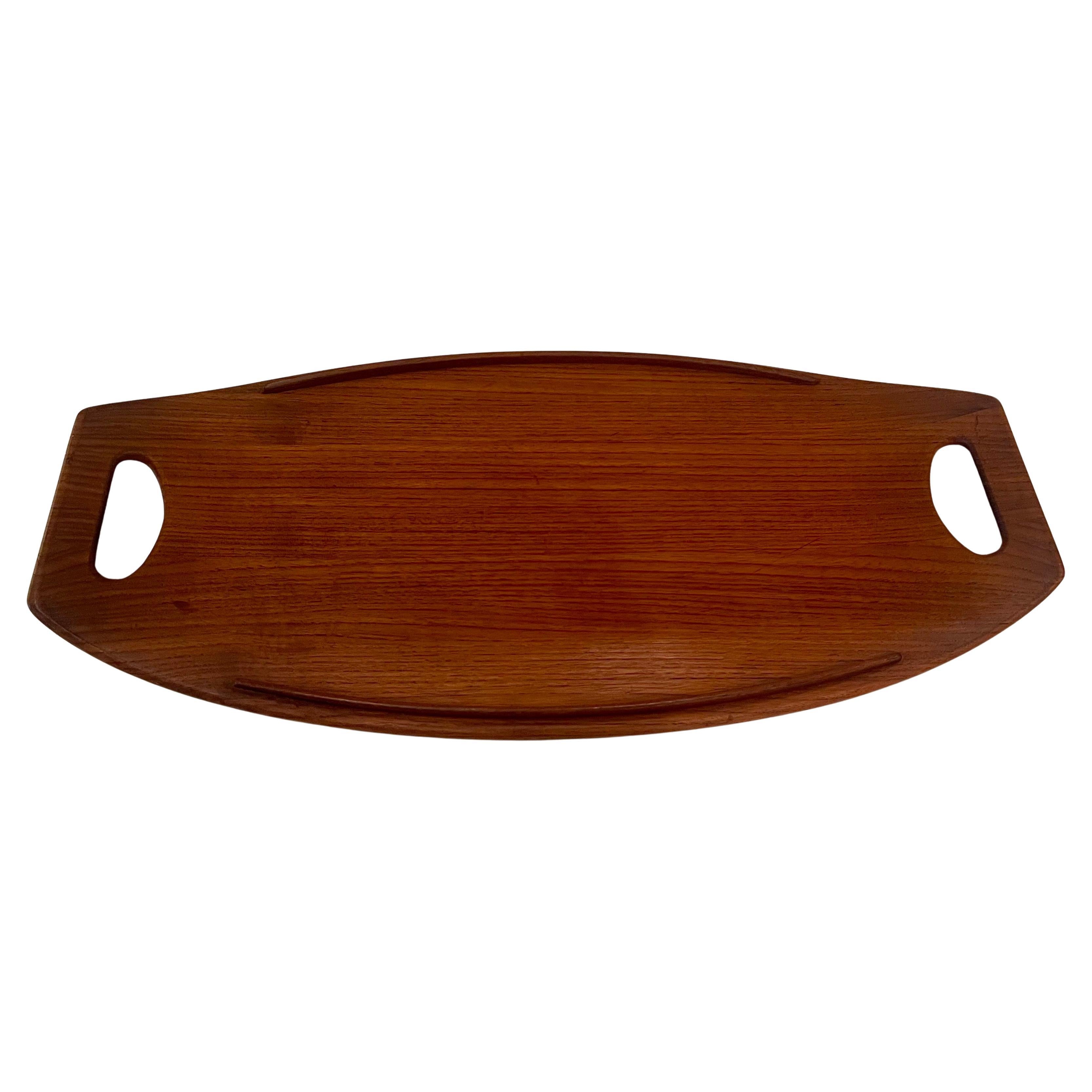 Beautiful solid teak gondola tray designed by Jens Quistgaard for Dansk; early production. Nice condition with raised edges and elegant lines. .with ducks logo