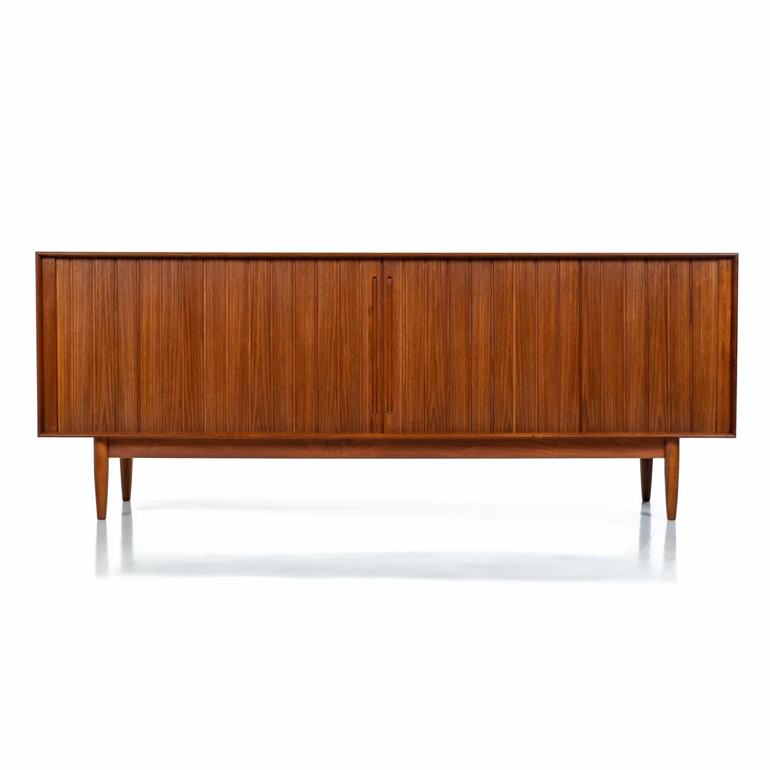 Mid-Century Modern Johannes Aasbjerg solid teak sideboard credenza. Made from 100% solid teak (except for the interior shelves), this sideboard is a perfect marriage of design and function, featuring exquisite craftsmanship, a finished back and lots