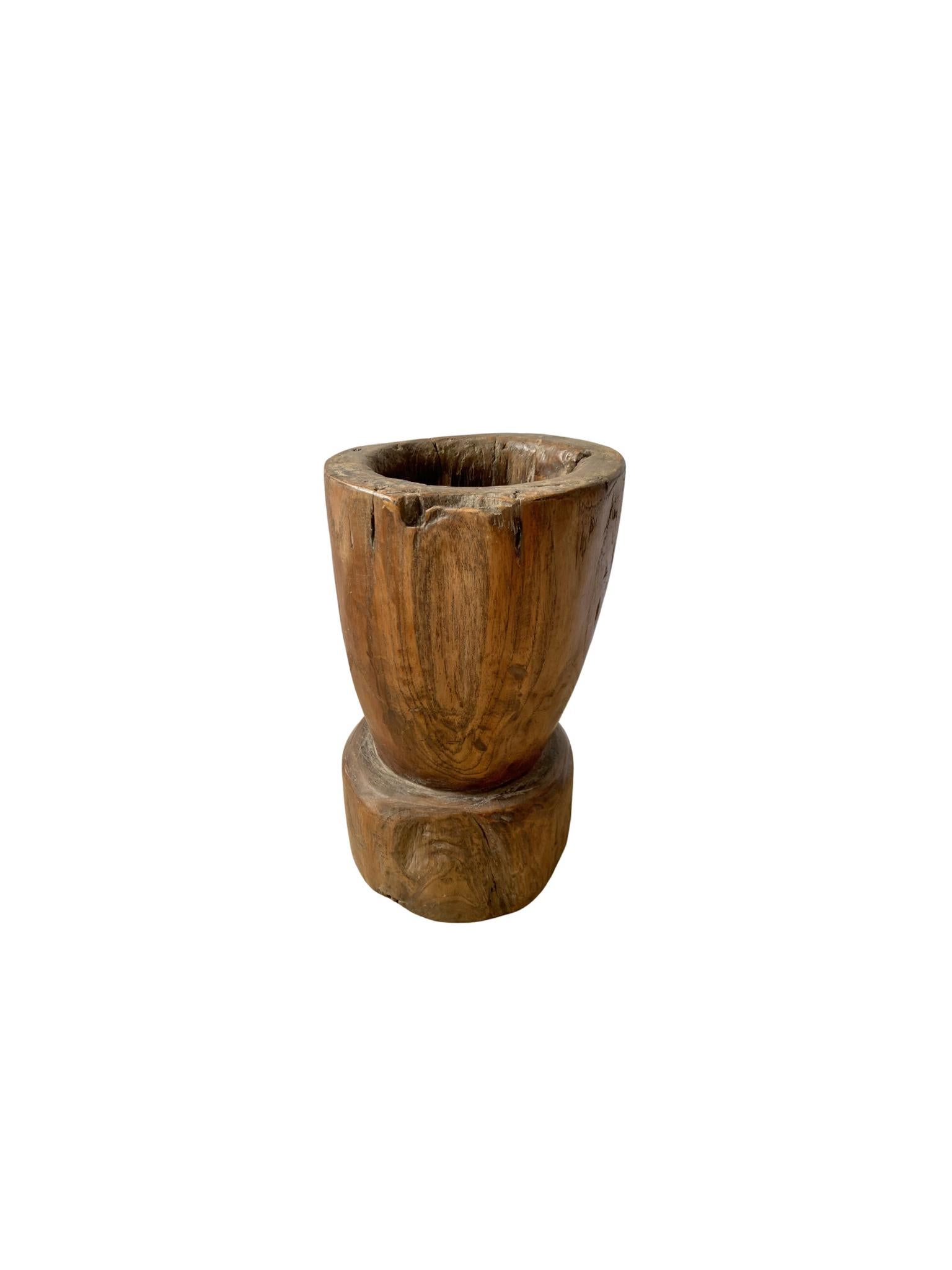 A vintage mortar bowl soured from rural Java & crafted from a solid teak wood slab. A raw and organic object with beautiful wood textures and imperfections. A versatile decorative object to bring warmth and life to any space, despite its once
