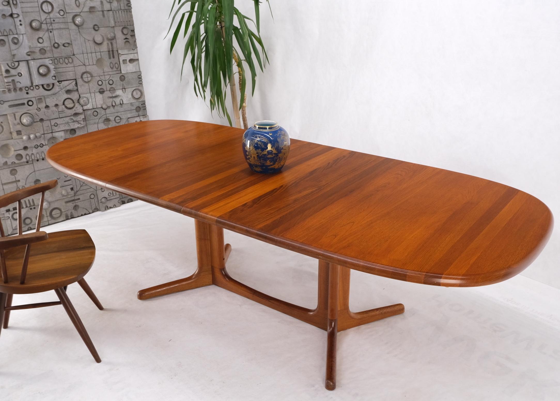 Solid teak oval danish mid century dining conference table 2 extension leaves.
Extension boards storage compartment.
Two table leaves each measuring 18'' across.