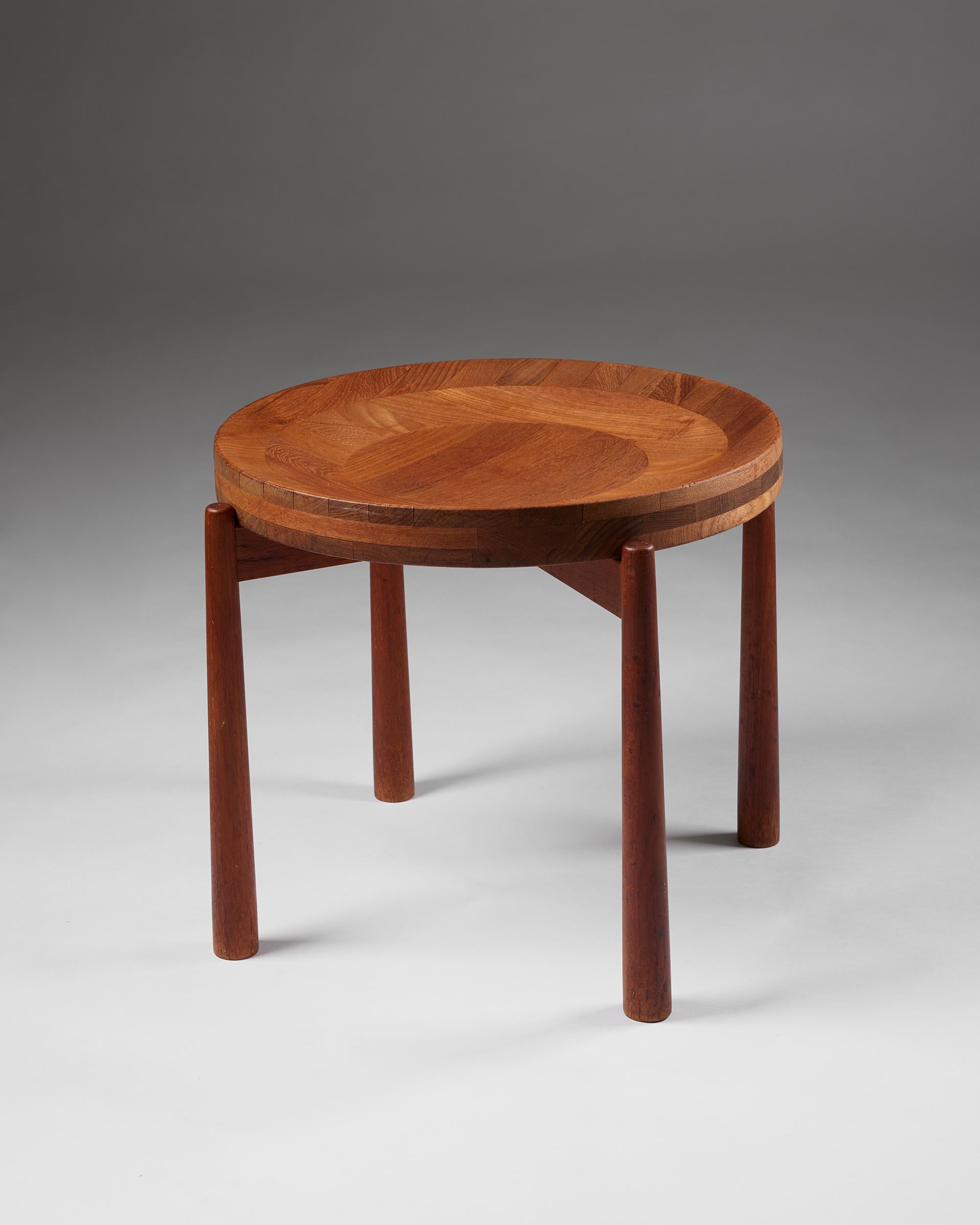 Side table designed by Jens Quistgaard,
Denmark, 1950s

Teak.

Exquisite woodwork and a beautifully shaped, removable tray surface that can function as a bowl characterise this Danish collectable. The sculptor Jens Harald Quistgaard worked with