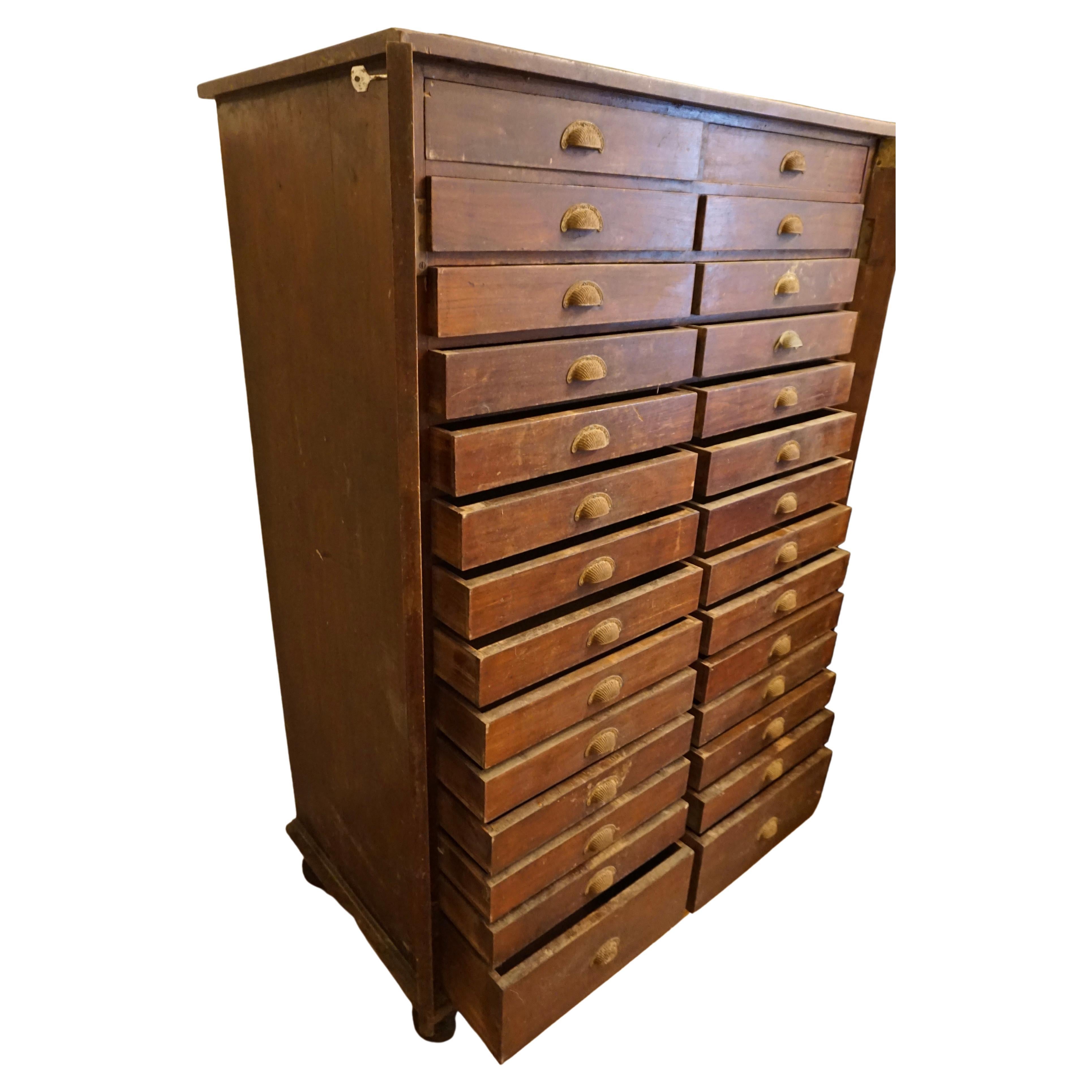Rare solid teak multi-drawer apothecary/file cabinet with locking mechanism and hardware in original patina. Beautifully aged metal pulls. Authentic and functional conversation piece oozing character from the 