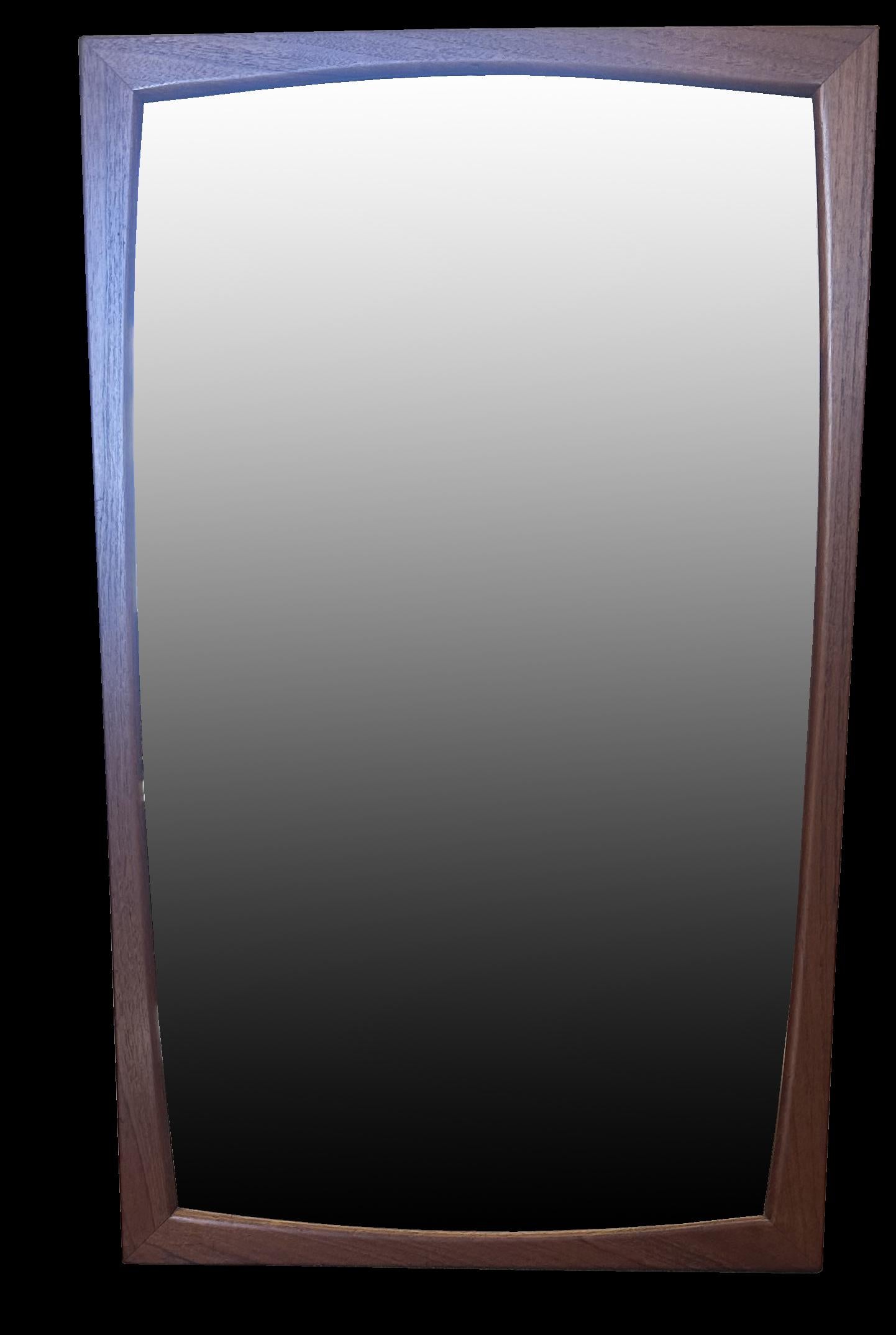 A very good solid teak wall mirror in classic Scandy Modern style,the frame shaped on all sides and with original glass mirror plate, with the model and maker stamped on the rear.