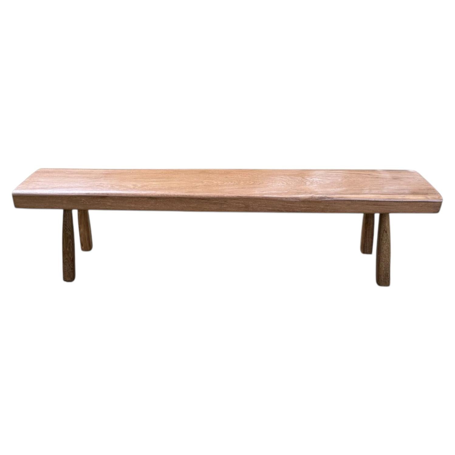 Solid Teak Wood Bench with Softened Edges and Sculptural Leg Form For Sale