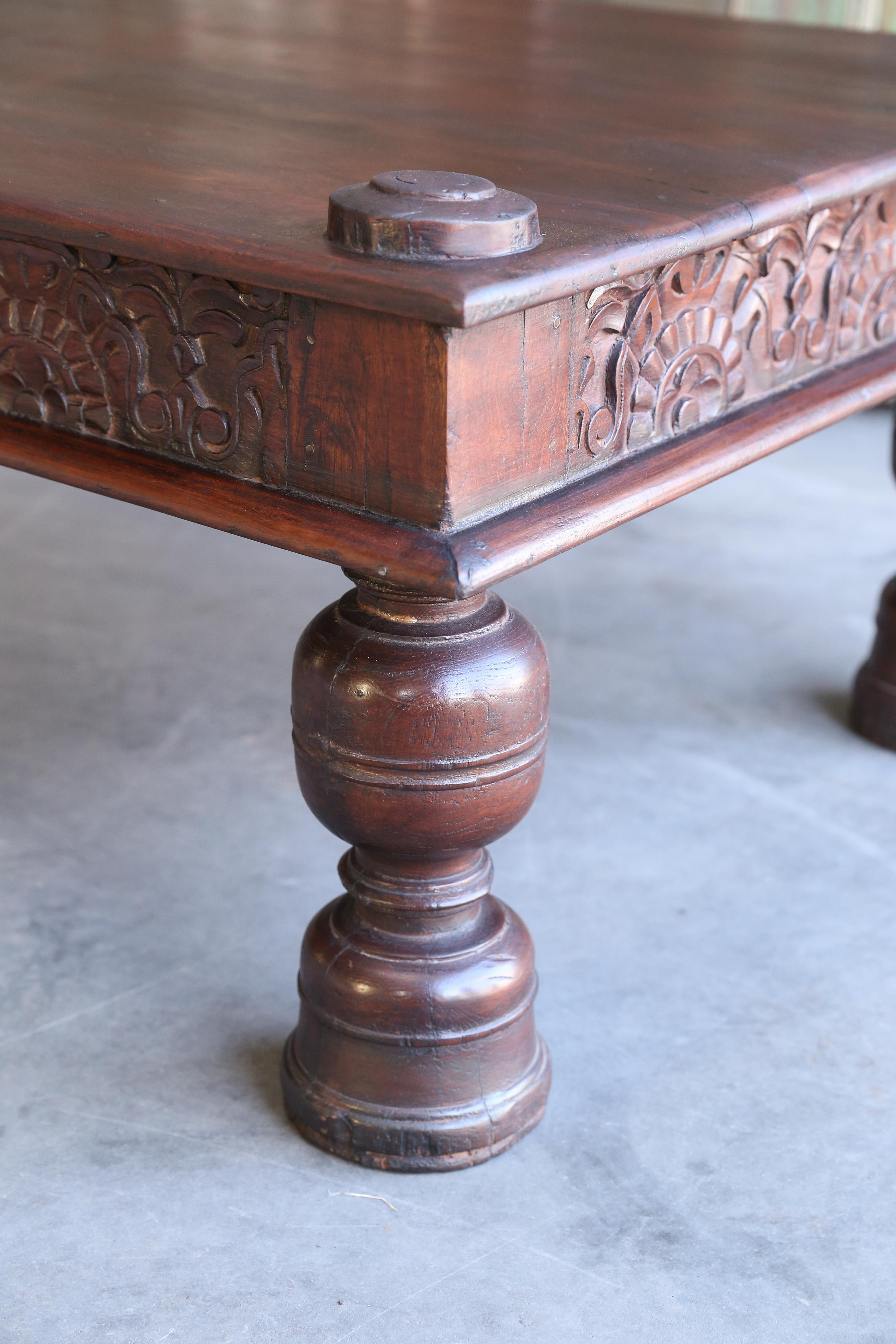 Made per customer design this is a heavily made solid teak wood coffee table. The legs and apron are finely shaped and carved. This is a typical example of the best in Anglo Raj furniture. It shows originality combined with day to day functional