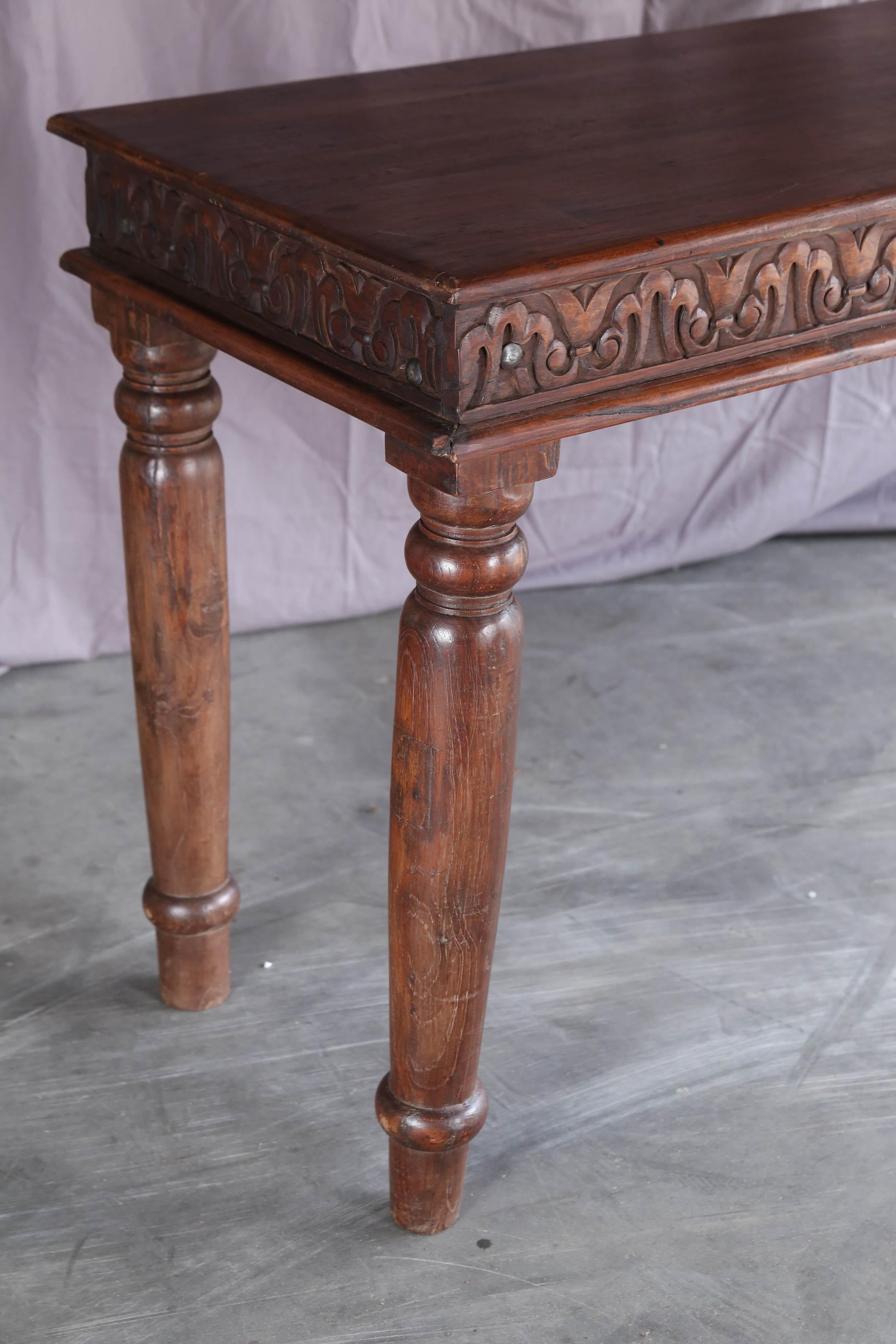 This is a typical colonial piece, used as a sofa table or as a consol table in the large high ceilinged colonial homes.
It is made of fine teak wood and with carved sides and finely hand-carved legs. Will last several decades.
Ideal for entry