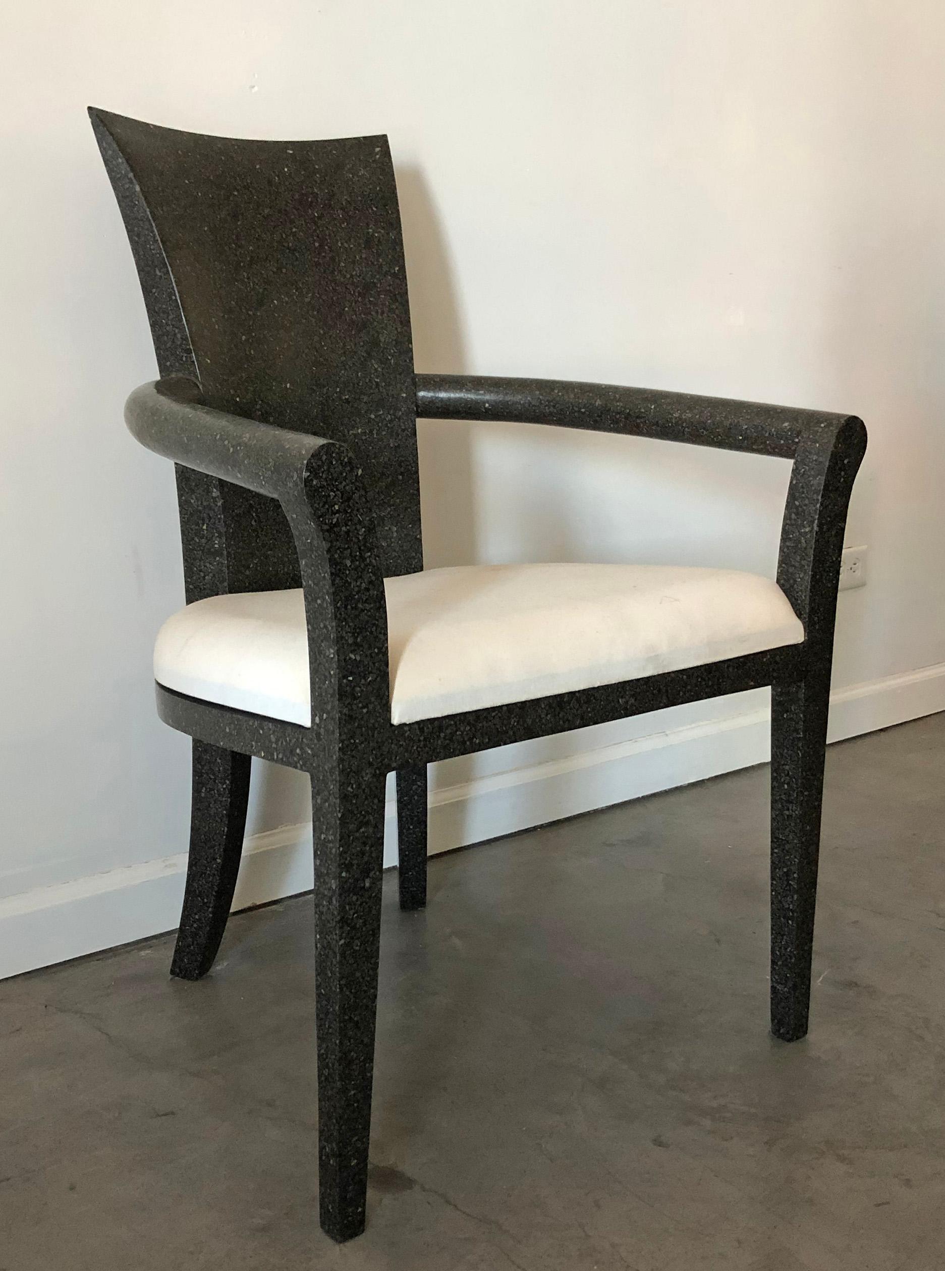An absolutely gorgeous solid terrazzo armchair by Carlo furniture. This armchair features a speckled black and grey terrazzo with a white muslin upholstered seat. 

Ideal as an accent chair, or desk chair; this gorgeous, smooth terrazzo armchair
