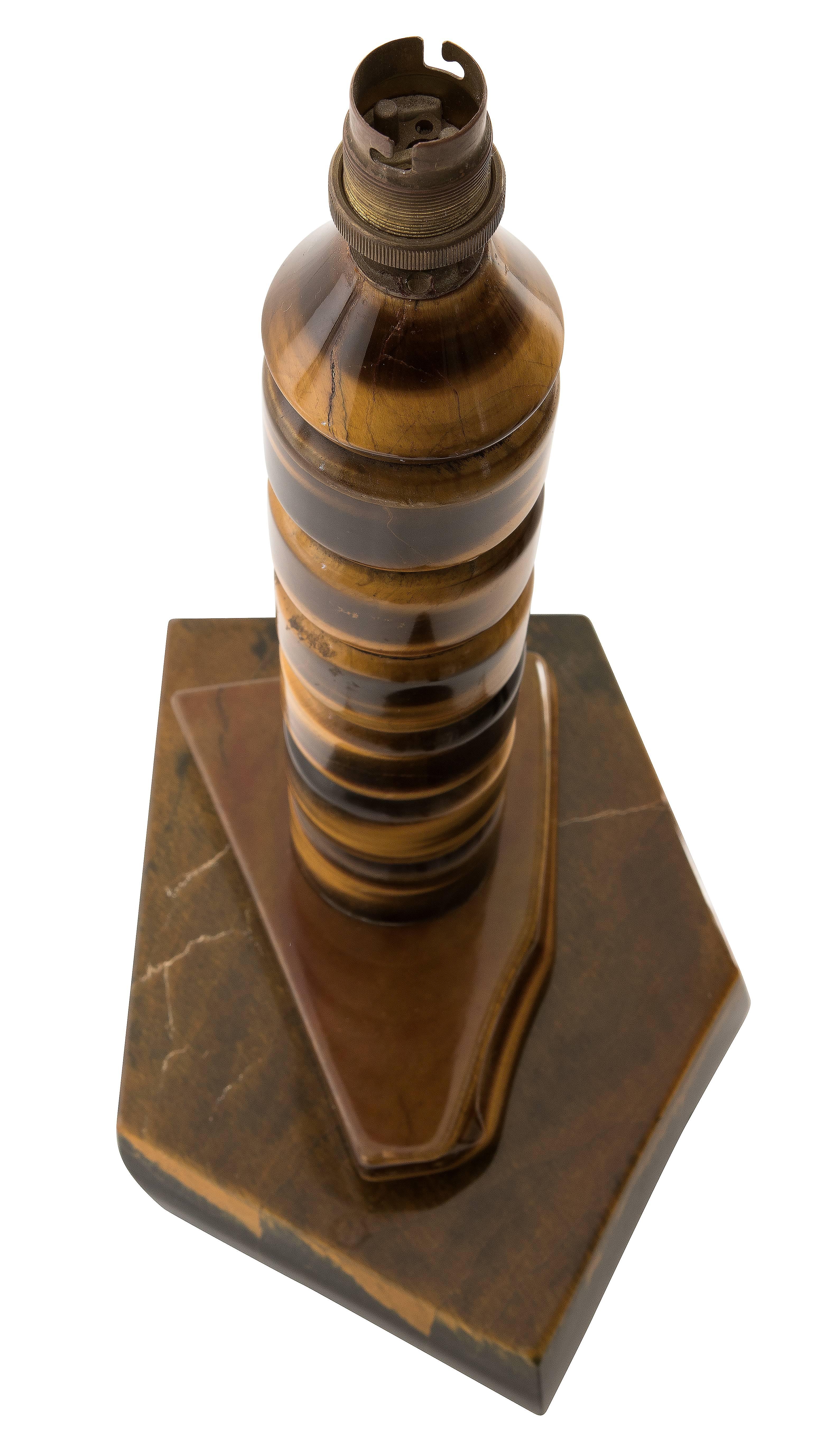 Solid tiger eye stone table lamp, lathe turned and polished from South Africa. 

Tiger's eye is a mineral with a silky lustre and distinctive red-brown golden coloring. In the 16th century it was more precious than gold, often used as eyes in