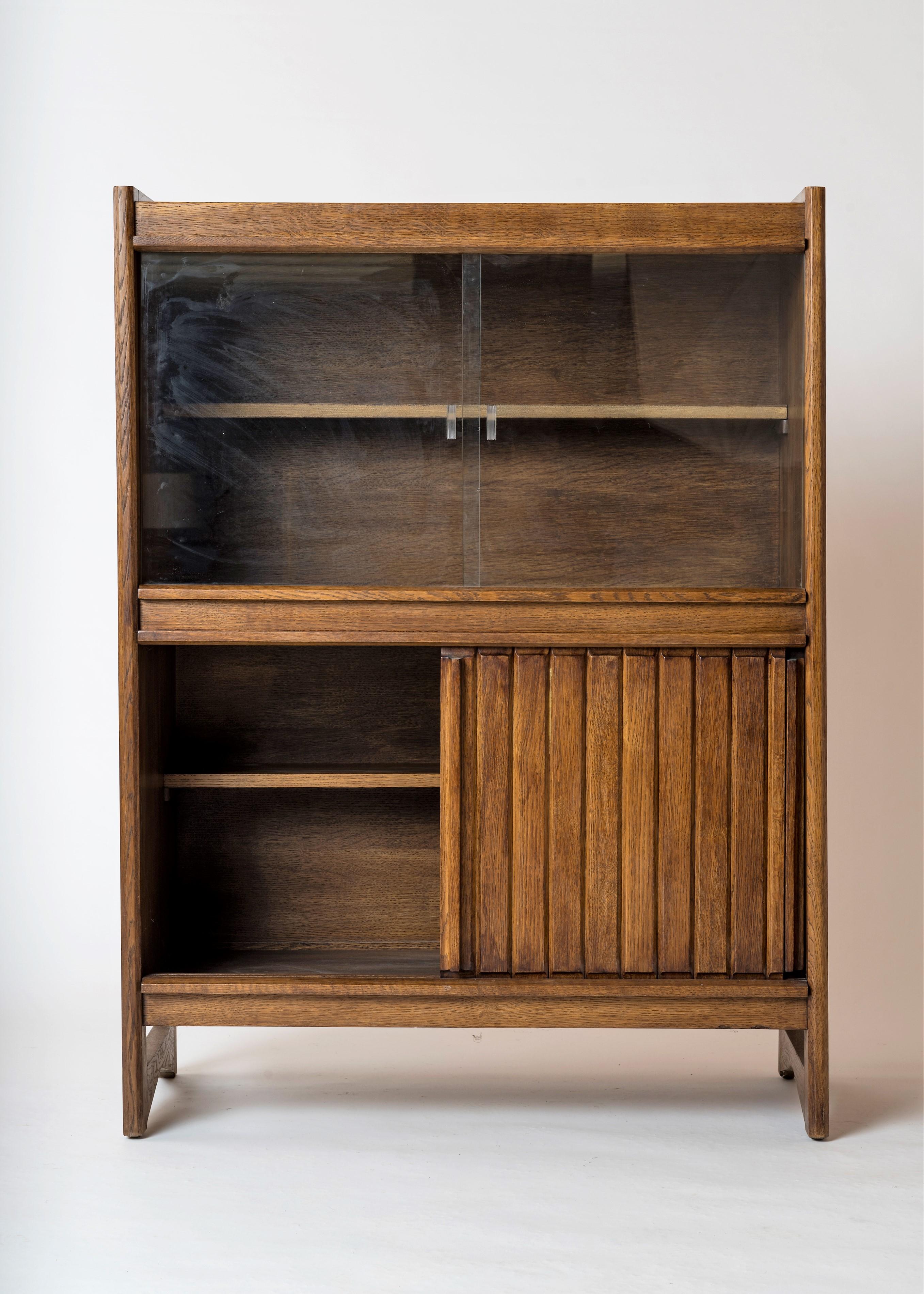 Elegantly crafted medium tinted solid oak cabinet by French iconic designers duo Guillerme & Chambron. 
