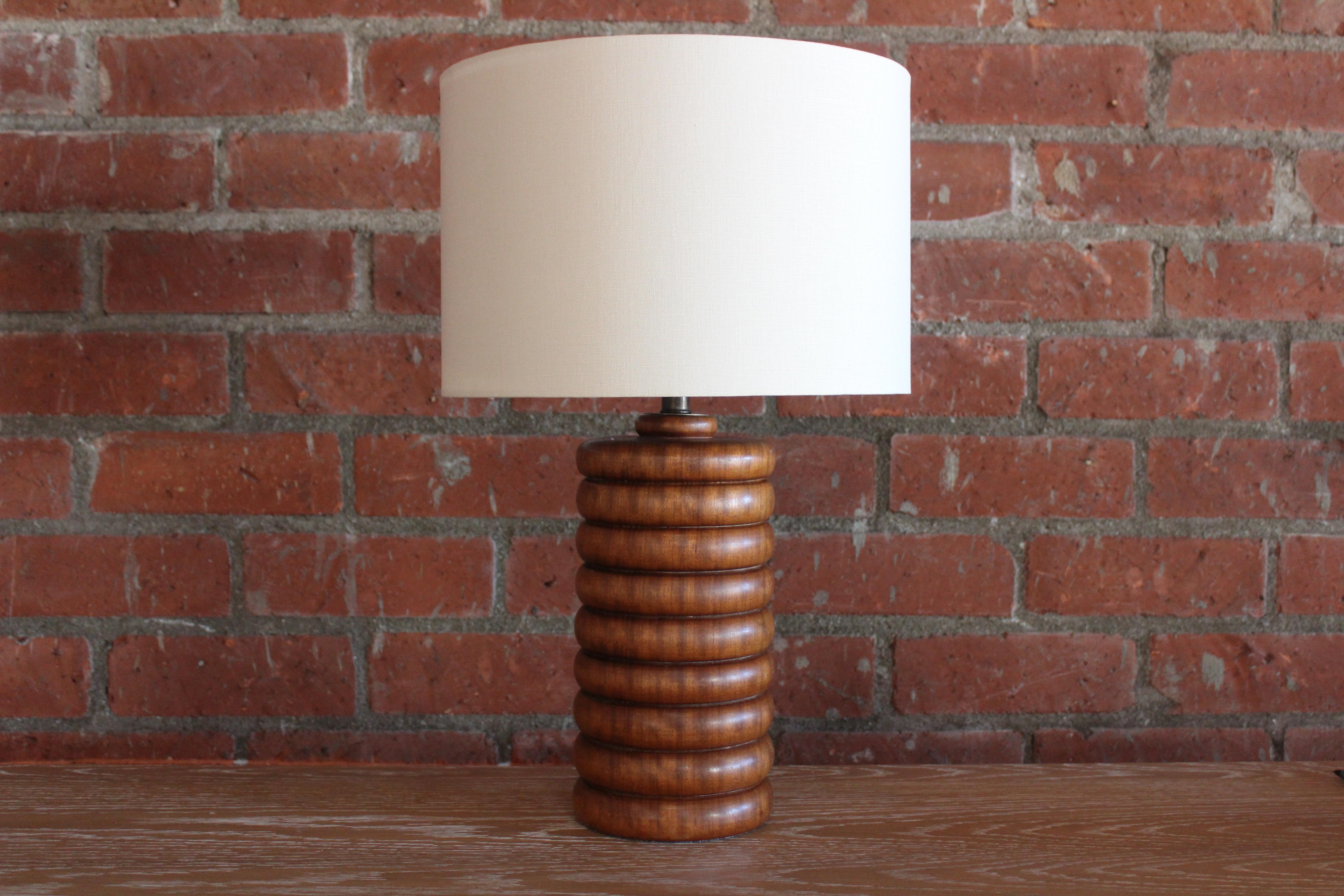 A vintage solid turned walnut table lamp, France, 1960s. Newly rewired with a custom shade in Belgian linen. 23